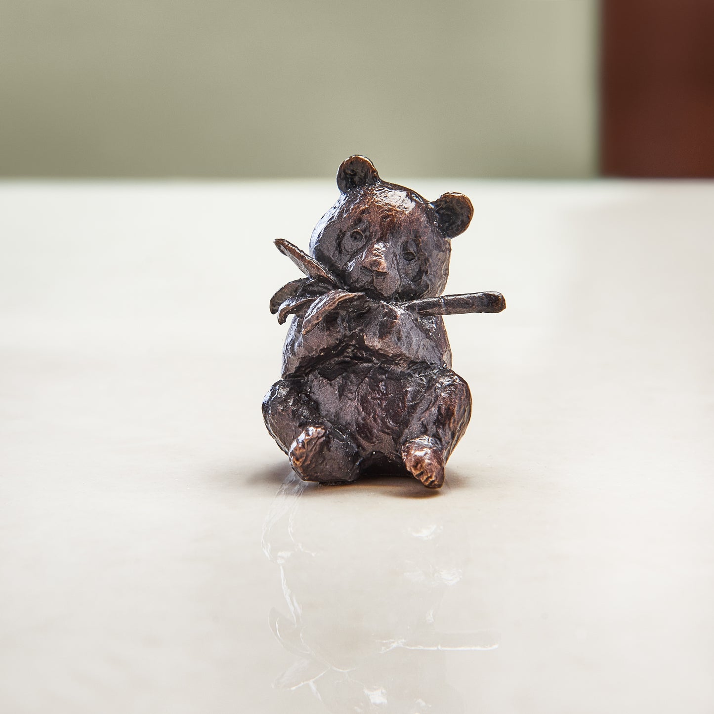 Miniature bronze figurine of a panda. Give as a bronze anniversary gift or thoughtful birthday gift.