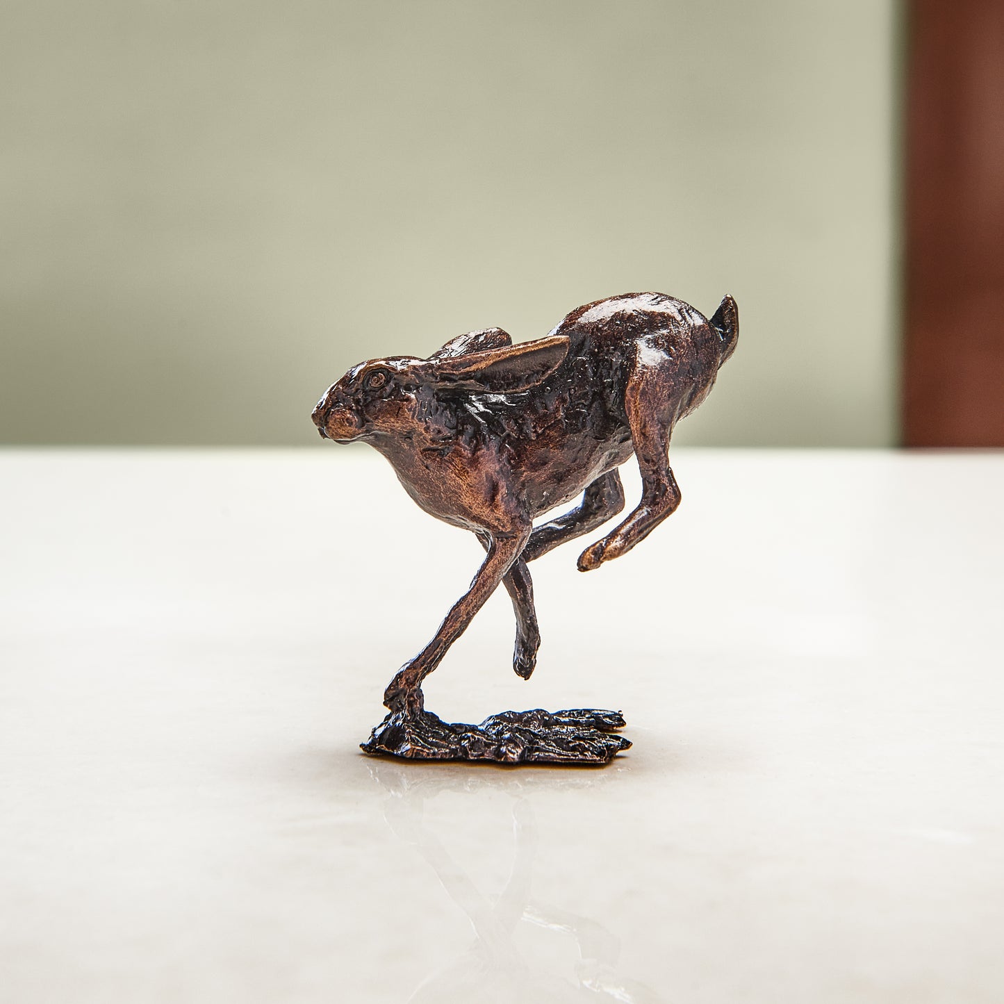 Miniature bronze figurine of a running hare. Give as a bronze anniversary gift or thoughtful birthday gift.