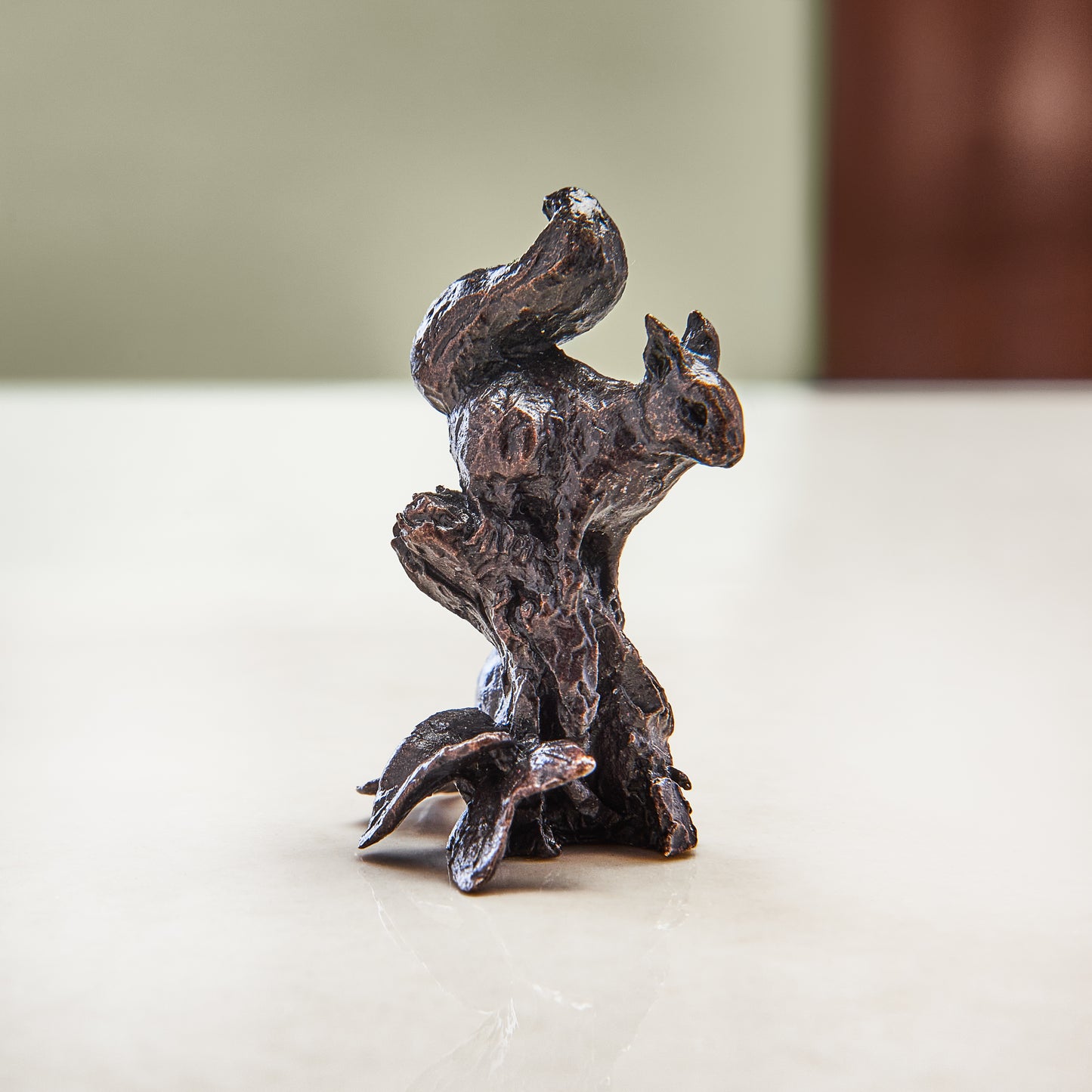 
                  
                    Miniature bronze figurine of a red squirrel, poised on a log. Give as a bronze anniversary gift or thoughtful birthday gift.
                  
                