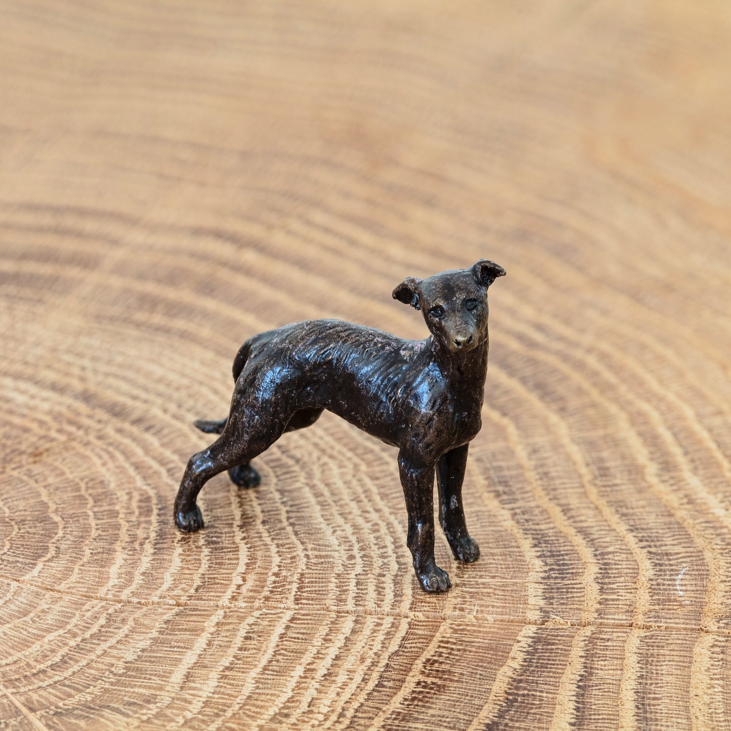 Miniature bronze sculpture of a loveable lurcher, ideal as a thoughtful bronze 8th anniversary gift or birthday gift.
