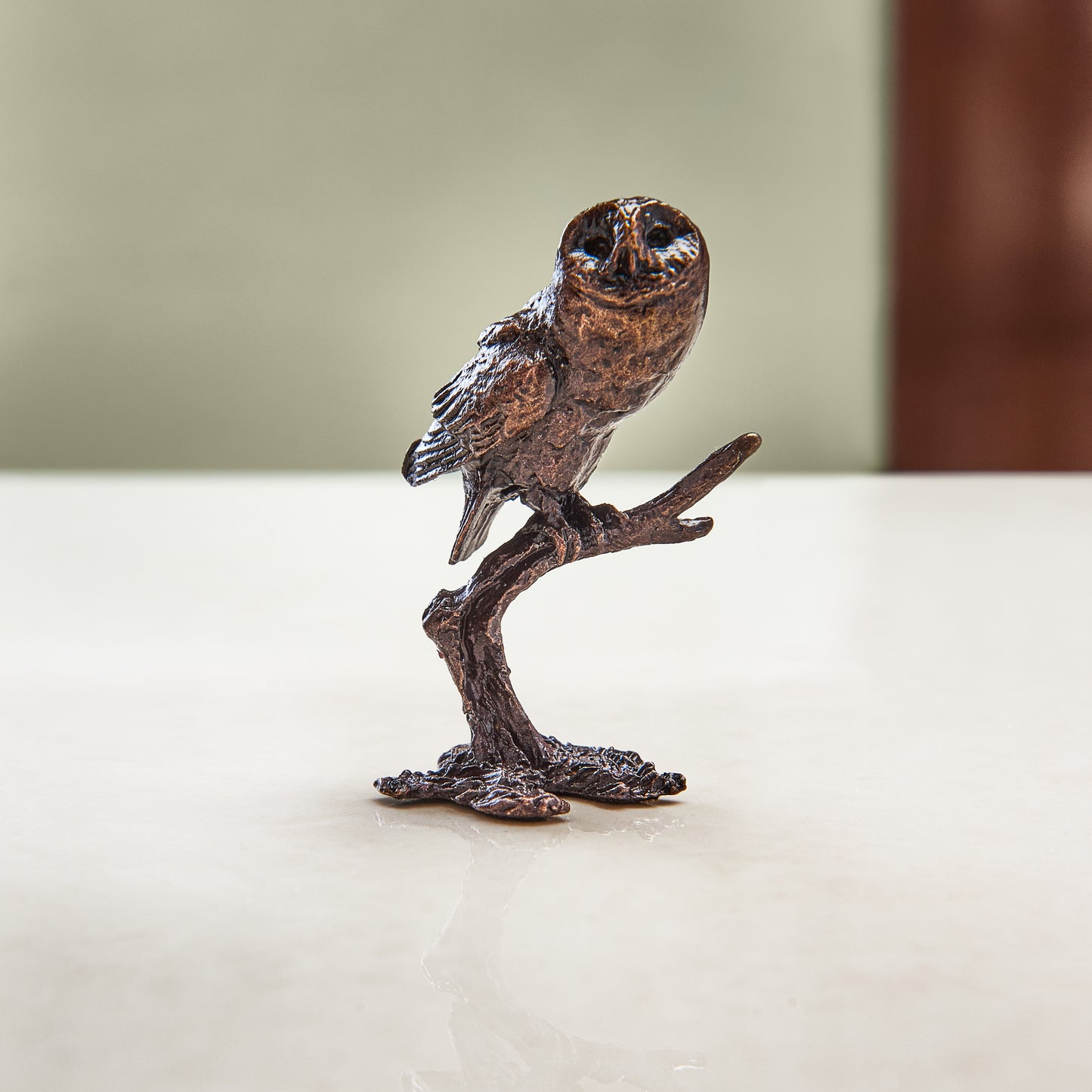 
                  
                    Miniature bronze figurine of a tawny owl perched on a branch. A perfect bronze anniversary gift.
                  
                