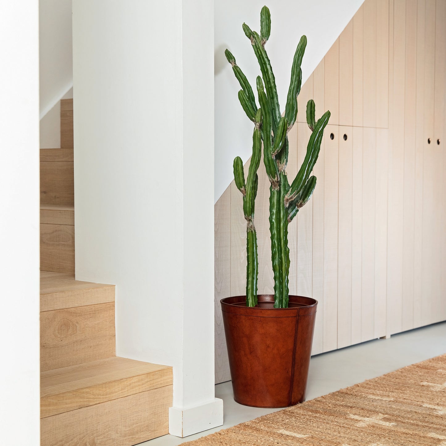 Leather plant pot with removable metal liner for use all over the home.