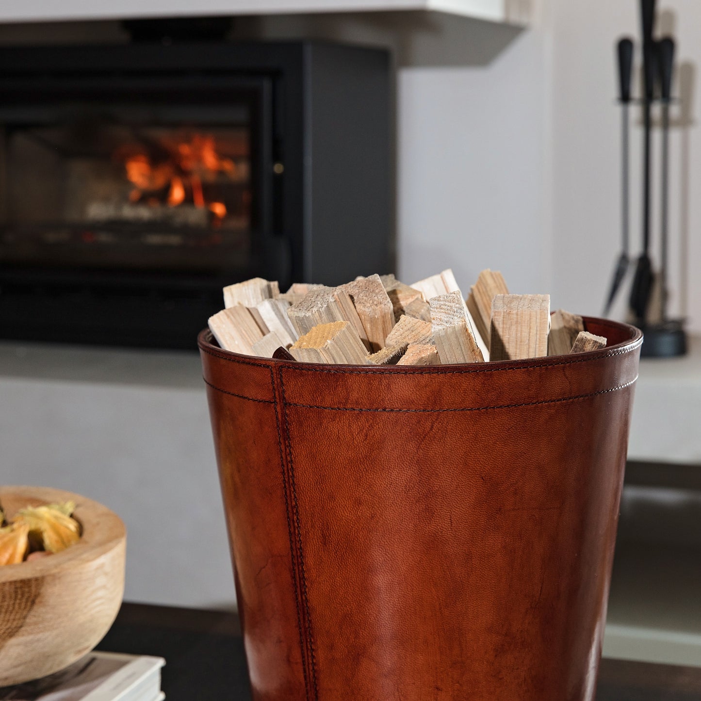 Leather kindling bin with removable metal liner for use in the home or office. Makes a practical gift for dad or a new home gift for special friends.