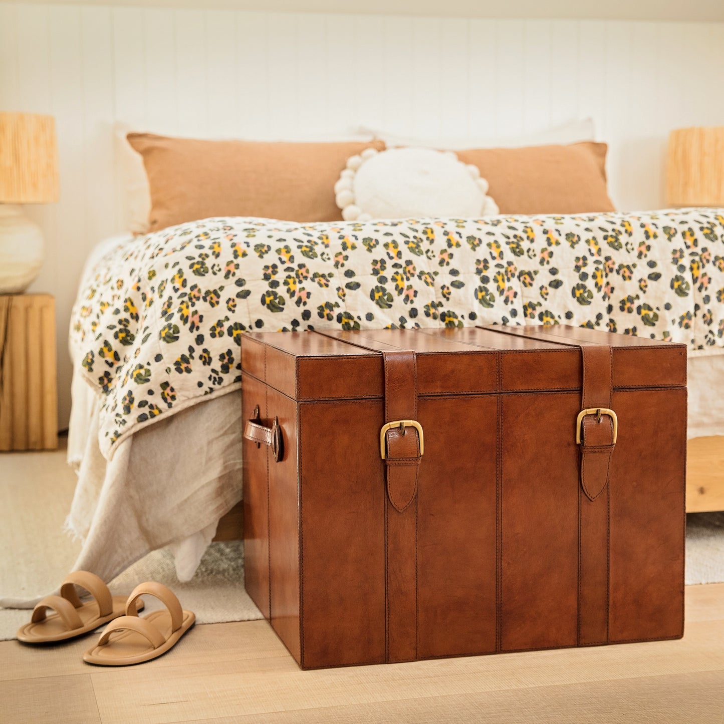 Timeless tan leather storage trunk ottoman with a lid and buckles. Use as a bedside table and personalise to create a wedding day gift to treasure forever.