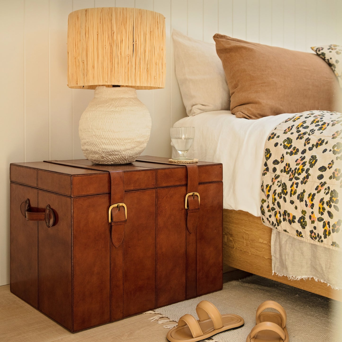 Timeless tan leather storage trunk ottoman with a lid and buckles. Use as a bedside table and personalise to create a wedding day gift to treasure forever.