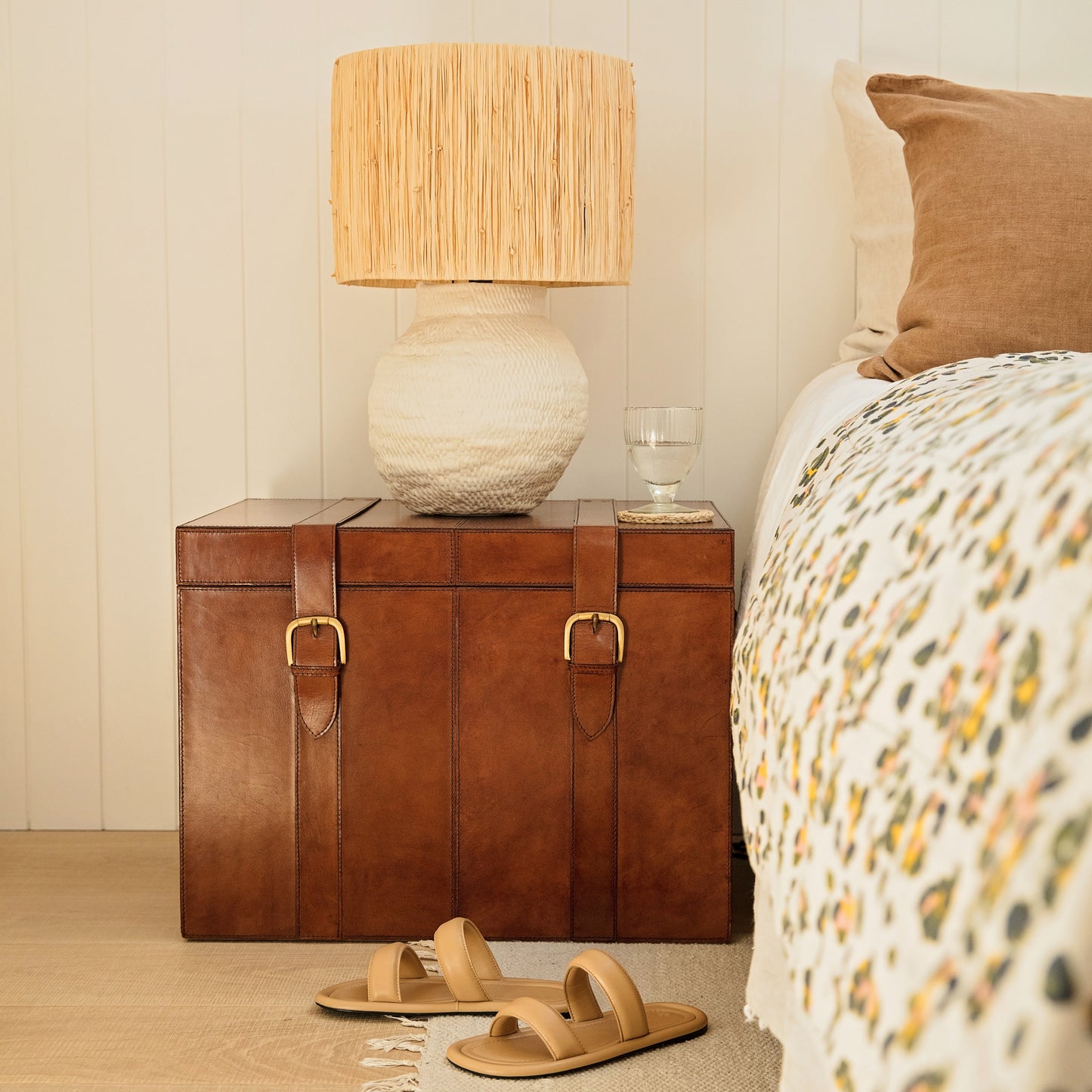 Timeless tan leather storage trunk ottoman with a lid and buckles. Use as a bedside table and personalise to create a wedding day gift to treasure forever.