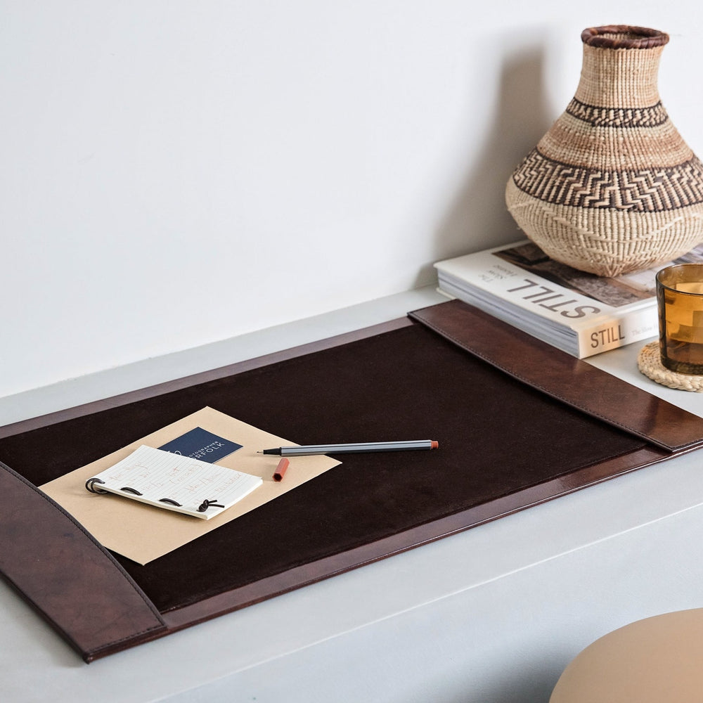 Dark brown leather desk blotter that protects work spaces and creates a comfortable writing area. Part of a collection of luxury desk accessories that make a thoughtful gift for him or her.