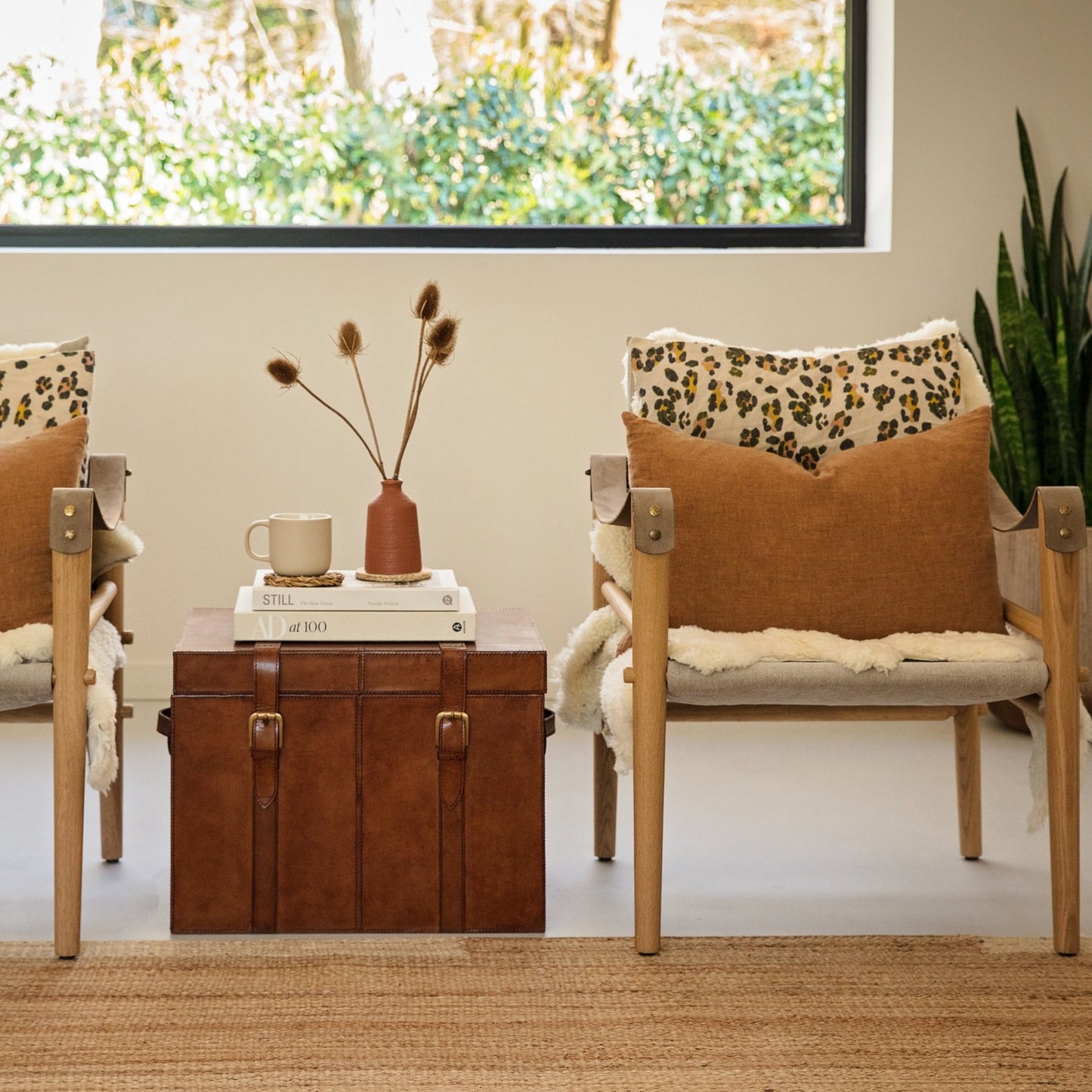 Tan leather storage trunk coffee table with buckles. Sit beside a favourite chair to use as a side table with storage for photo albums and board games. Personalise as a thoughtful new home gift.