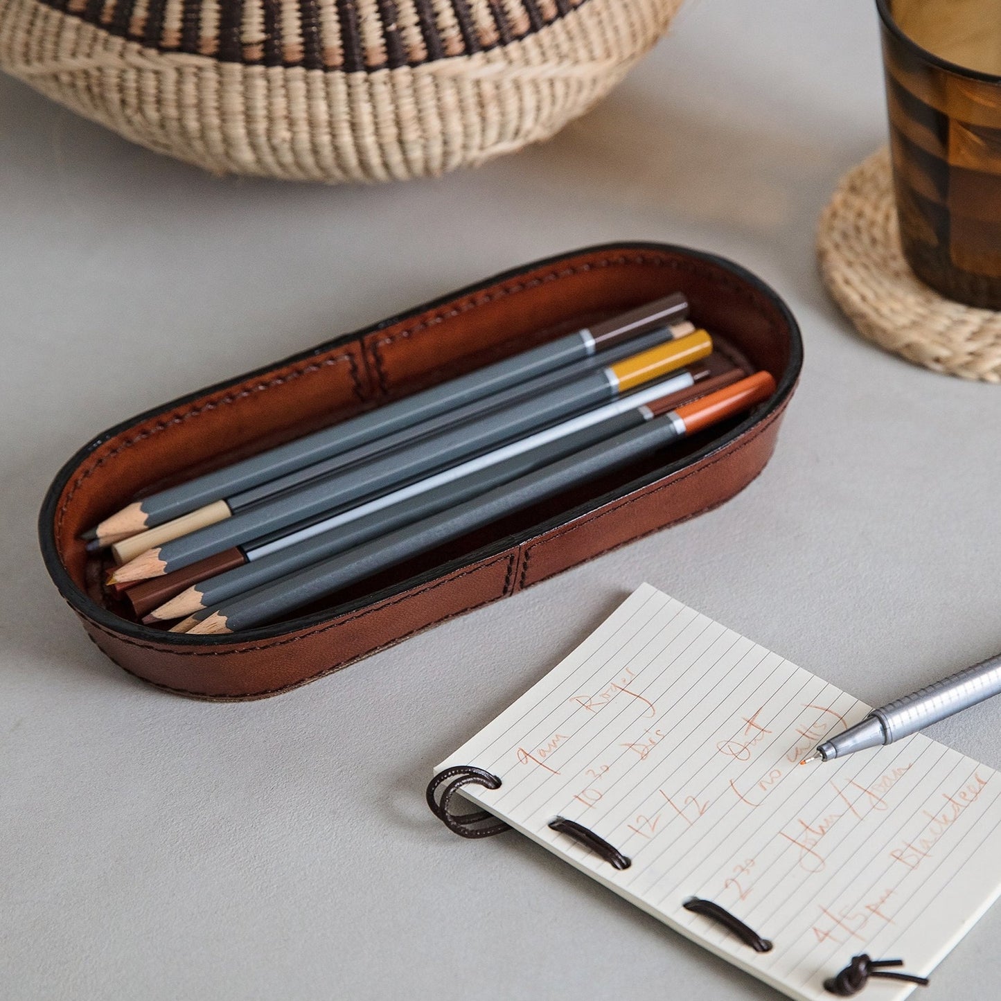 Pen tray for a desk or sideboard, made from soft tan leather. Timeless oval shape ideal for holding glasses too. Part of a collection of stylish desk and home accessories, that make practical gifts for him or her.