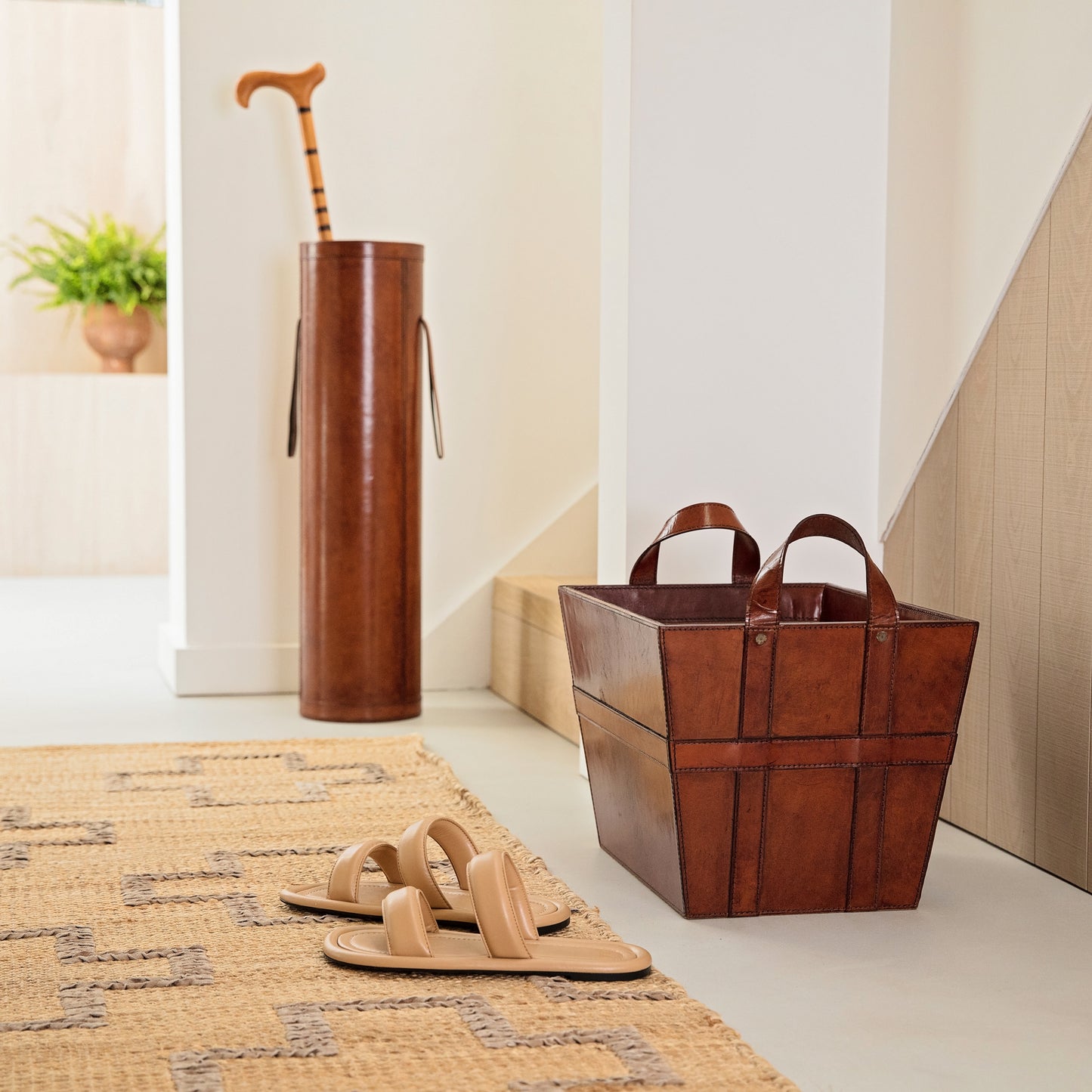 Hallway storage set combining our tan leather stick stand and storage basket. Both have sturdy handles for moving around and have a suede lining. Gift to a happy couple on their third anniversary.
