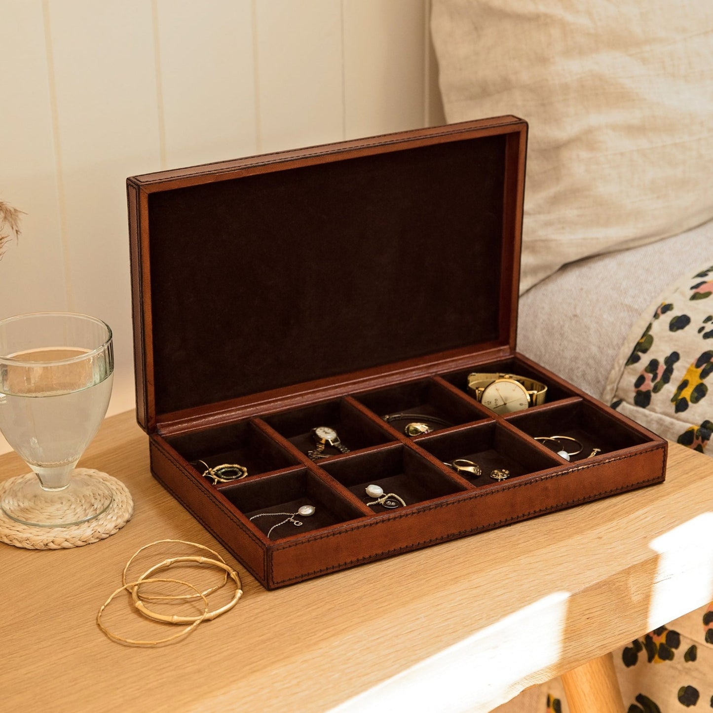 Rectangular flat jewellery box in tan leather, with 8 small compartments to hold a collection of rings, necklaces or bracelets. Personalise with their name or the contents as a timeless gift for an anniversary.