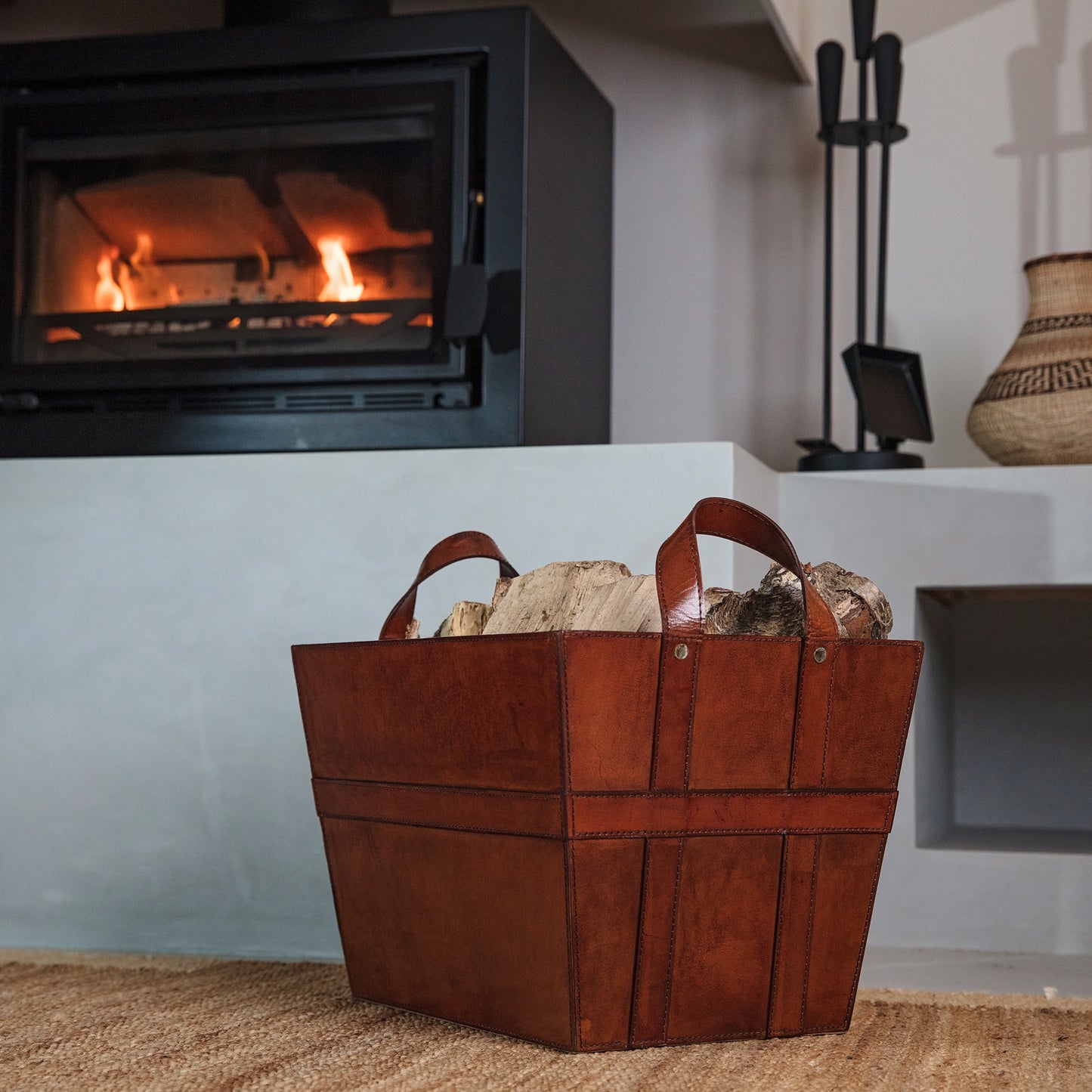 Sturdy rectangular tan leather log basket with handles. Ideal for carrying and storing logs and kindling. Personalise for a thoughtful retirement gift.