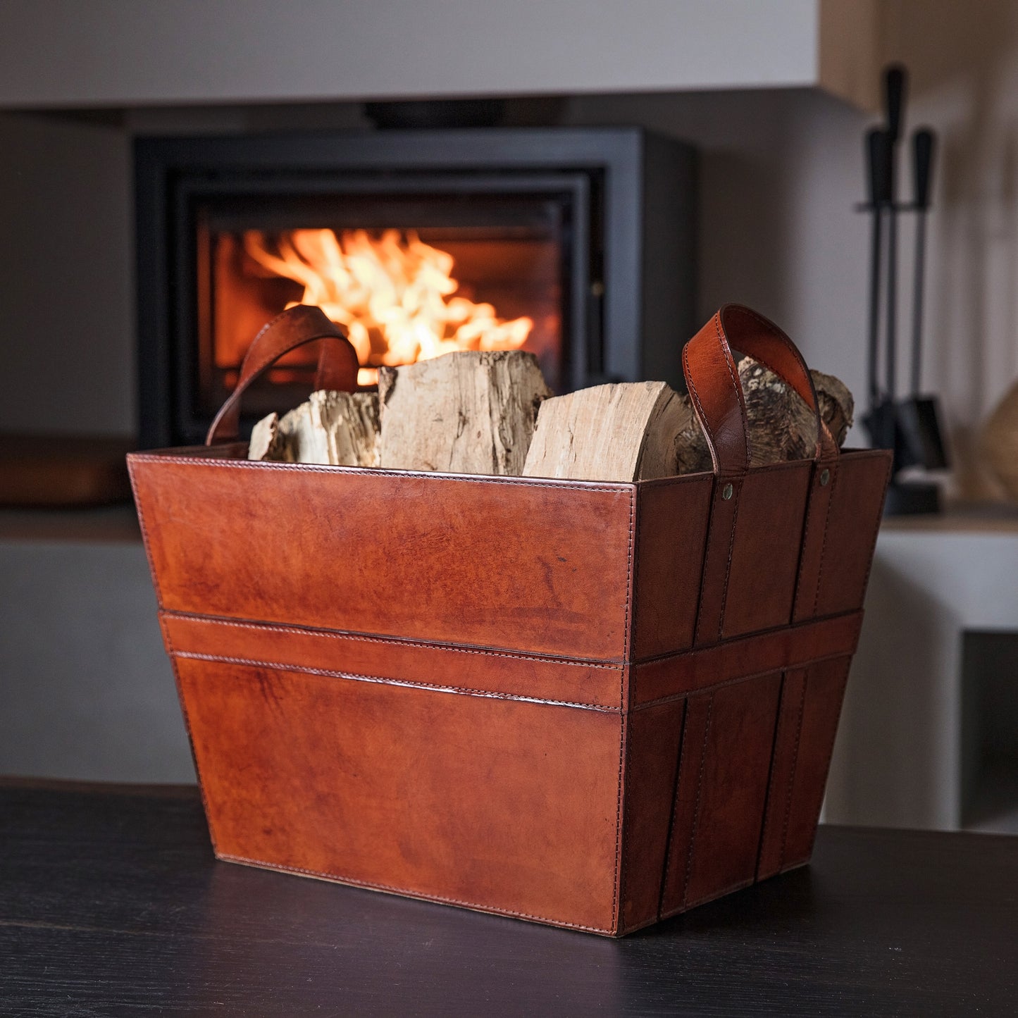 Sturdy rectangular tan leather log basket with handles. Ideal for carrying and storing logs and kindling. Personalise for a thoughtful retirement gift.