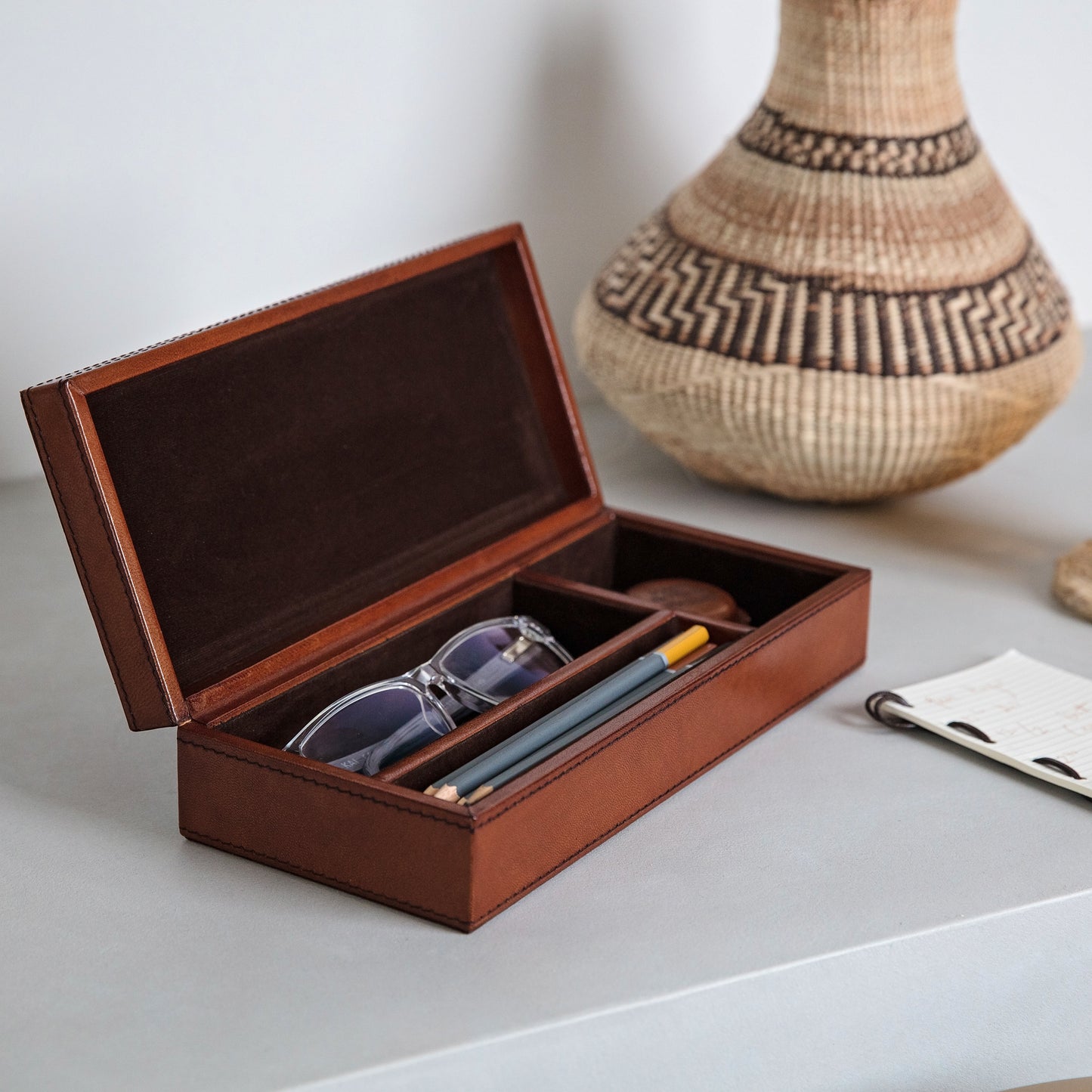 Rectangular leather desk tidy box in tan with suede interior. Perfect for keeping desks clutter free. Part of a collection of stylish desk accessories, that make thoughtful gifts for him and her.