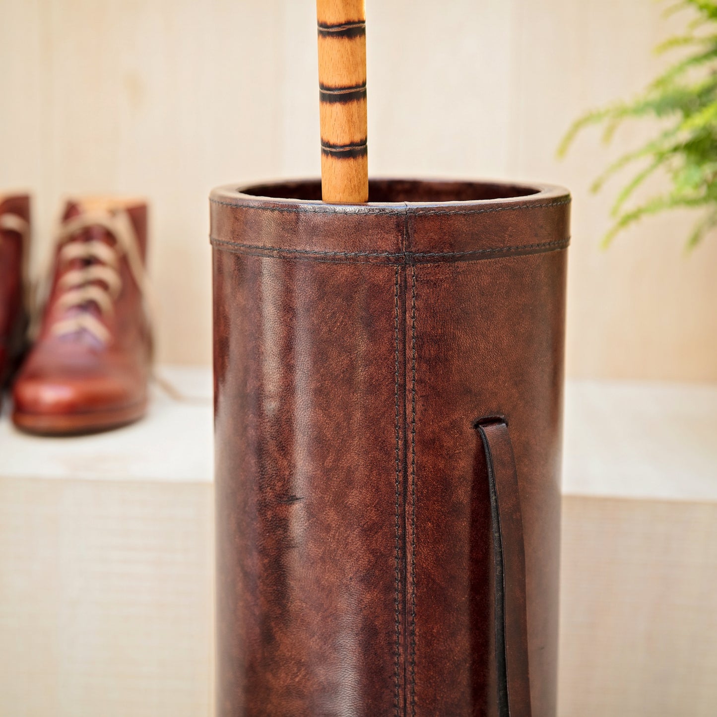 Classic brown leather cylindrical walking stick stand for easy hallway storage.  Personalise for a thoughtful milestone birthday gift.