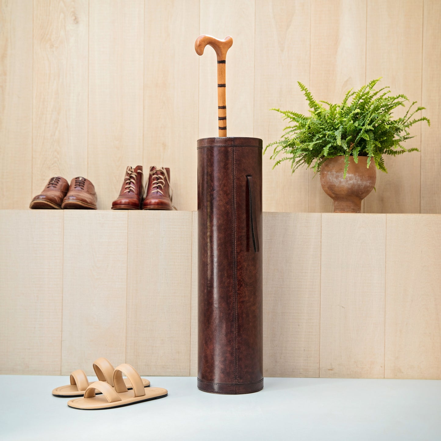 Classic brown leather cylindrical walking stick stand for easy hallway storage.  Personalise for a thoughtful milestone birthday gift.
