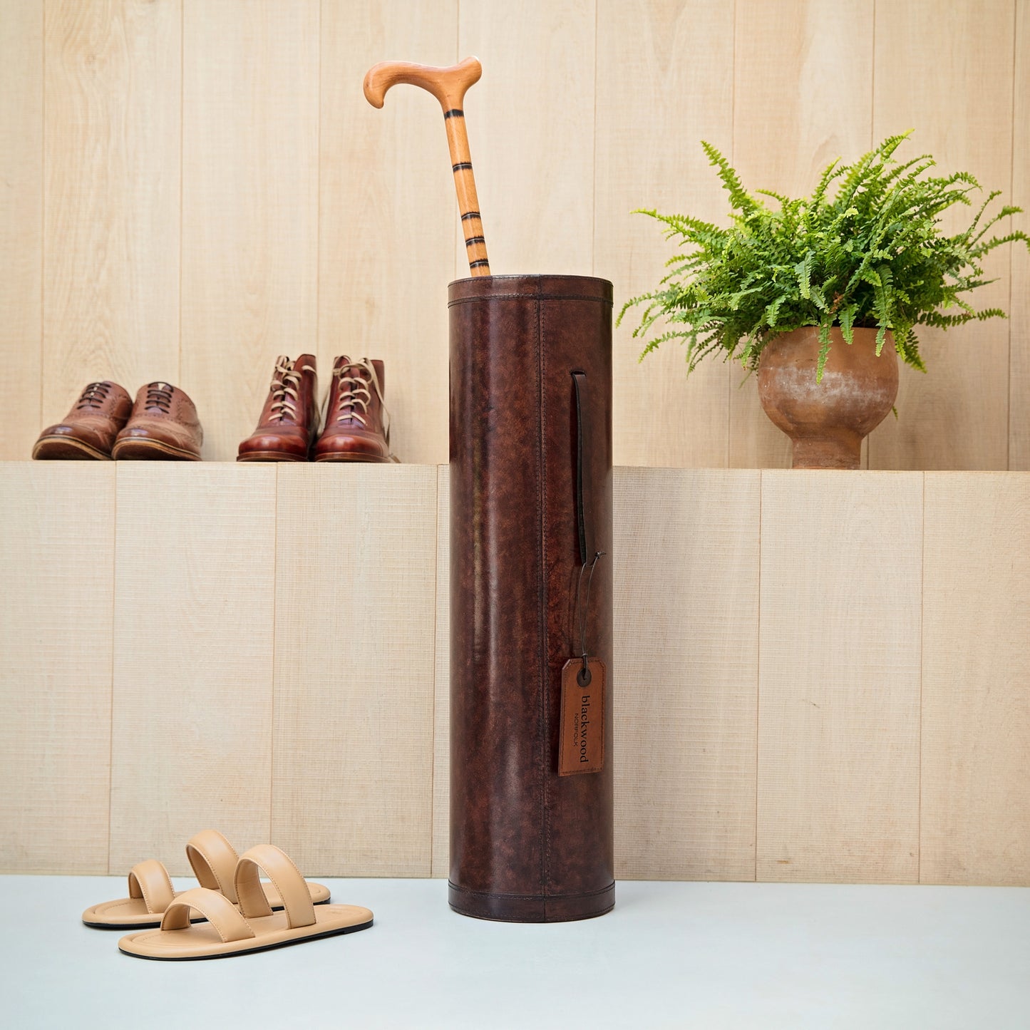 Classic brown leather cylindrical walking stick stand for easy hallway storage.  Personalise for a thoughtful milestone birthday gift.