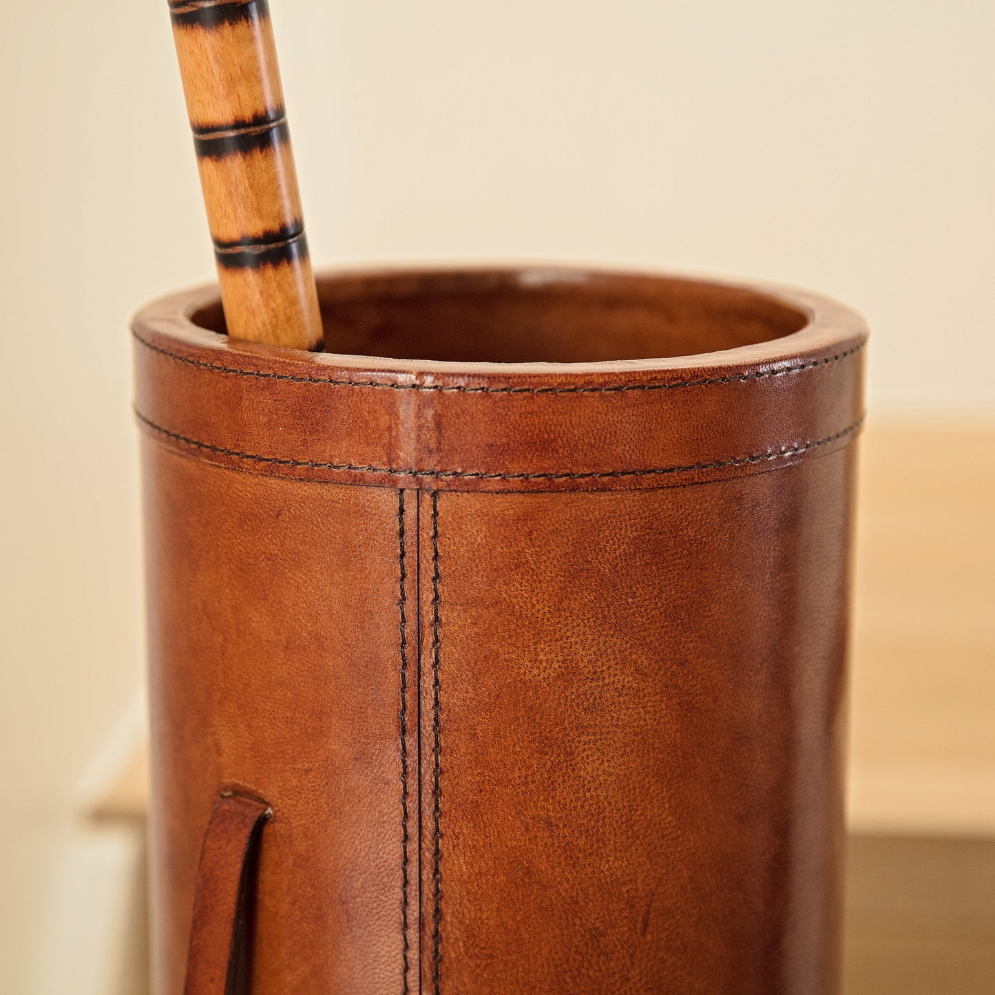 Classic tan leather cylindrical walking stick stand for easy hallway storage.  Personalise for a thoughtful milestone birthday gift.