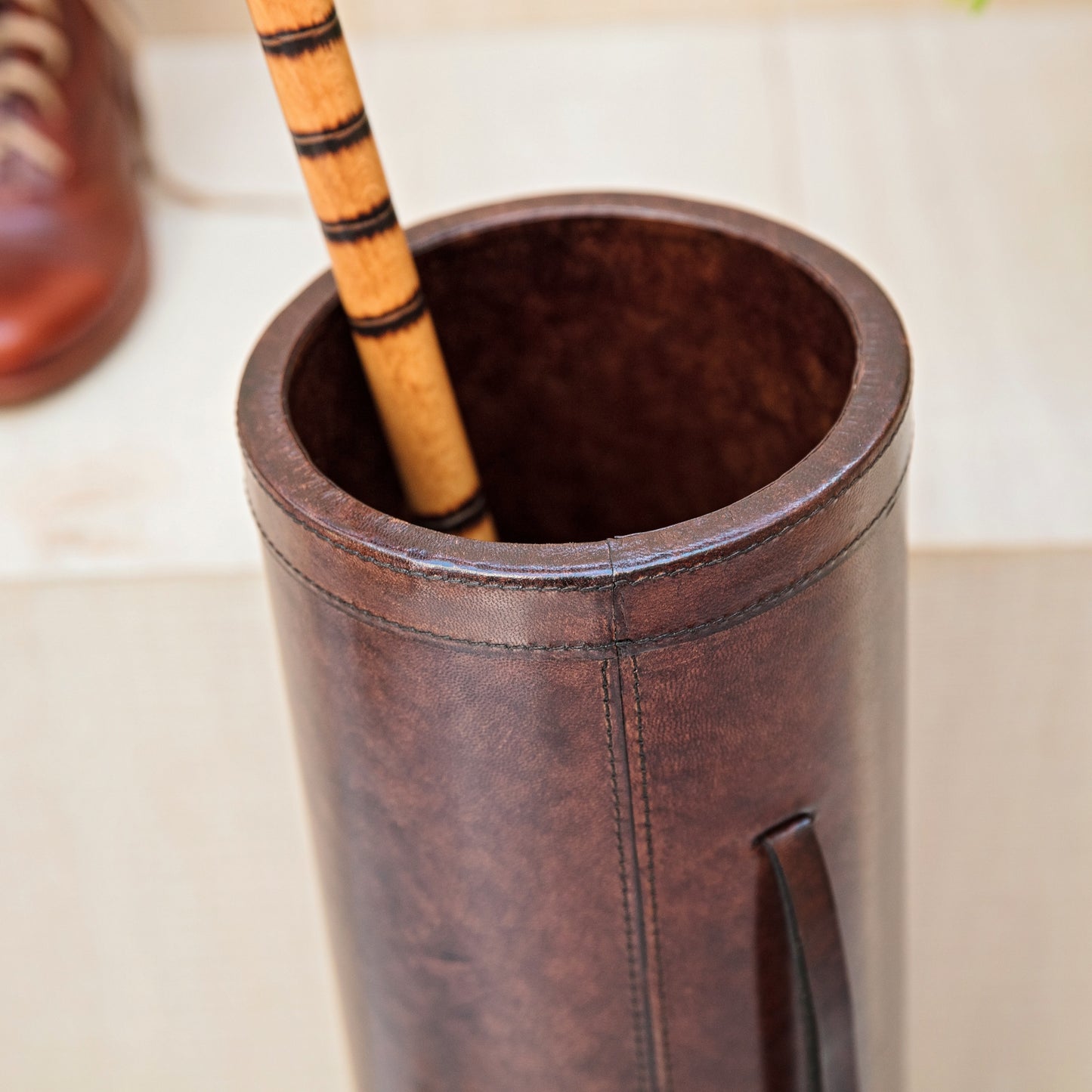Classic brown leather cylindrical walking stick stand for easy hallway storage.  Personalise for a thoughtful milestone birthday gift.
