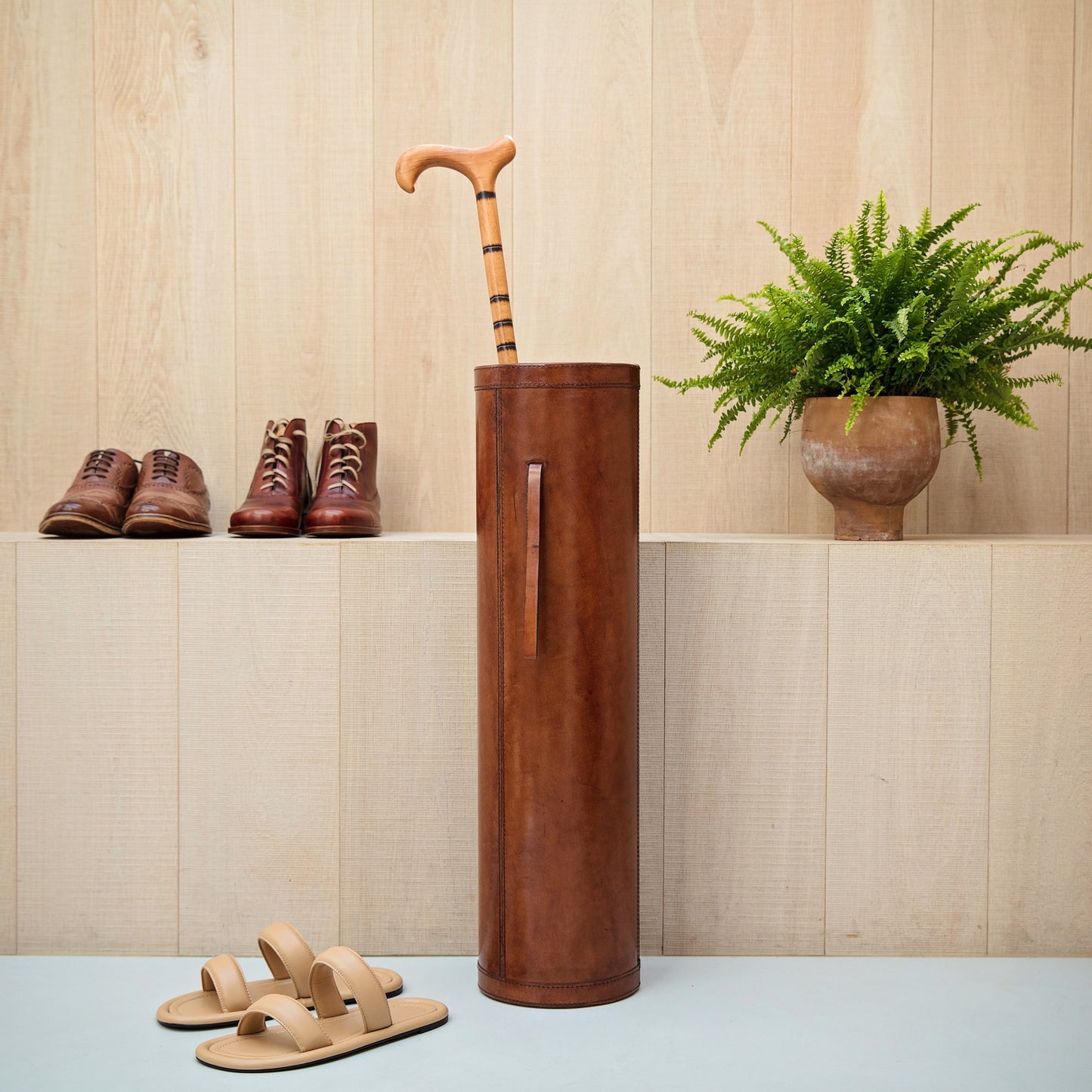 Classic tan leather cylindrical walking stick stand for easy hallway storage.  Personalise for a thoughtful milestone birthday gift.