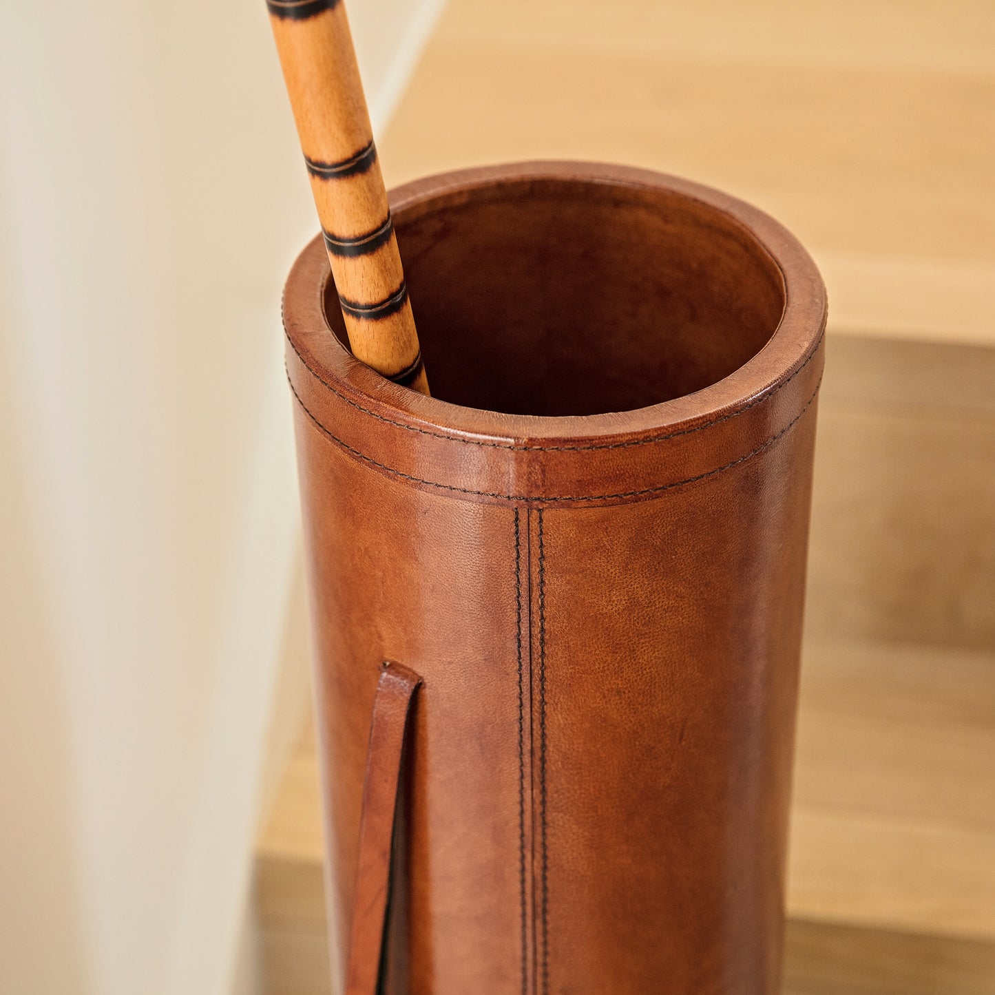 Classic tan leather cylindrical walking stick stand for easy hallway storage.  Personalise for a thoughtful milestone birthday gift.
