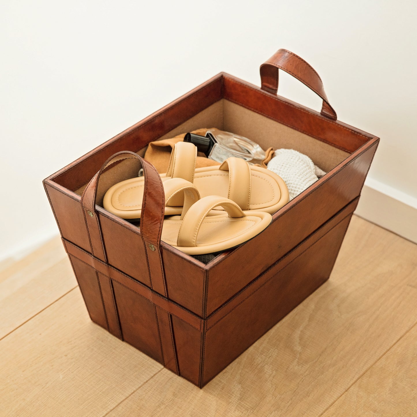 Rectangular tan leather magazine basket with handles. Sturdy and stylish its ideal for storing shoes, accessories or magazines. Personalise with a name to create a unique third anniversary gift.