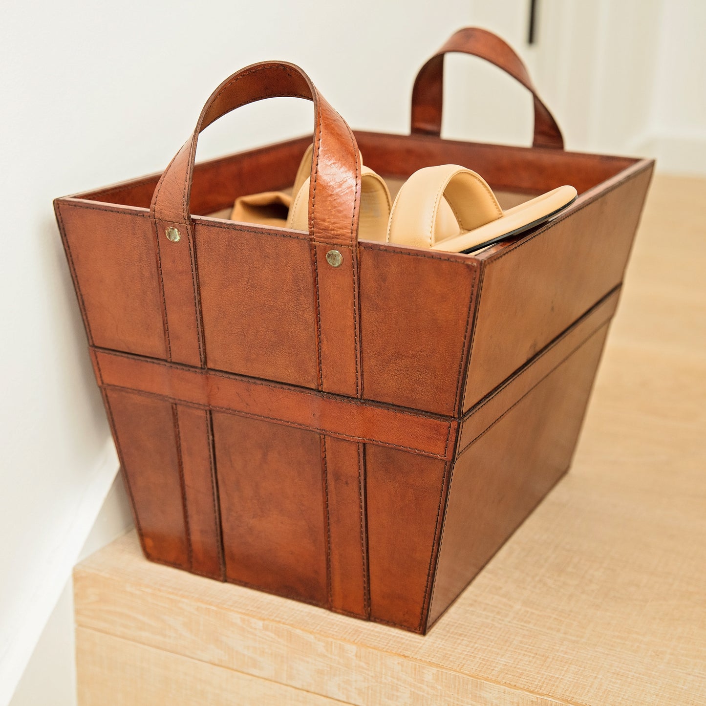 Rectangular tan leather magazine basket with handles. Sturdy and stylish its ideal for storing shoes, accessories or magazines. Personalise with a name to create a unique third anniversary gift.