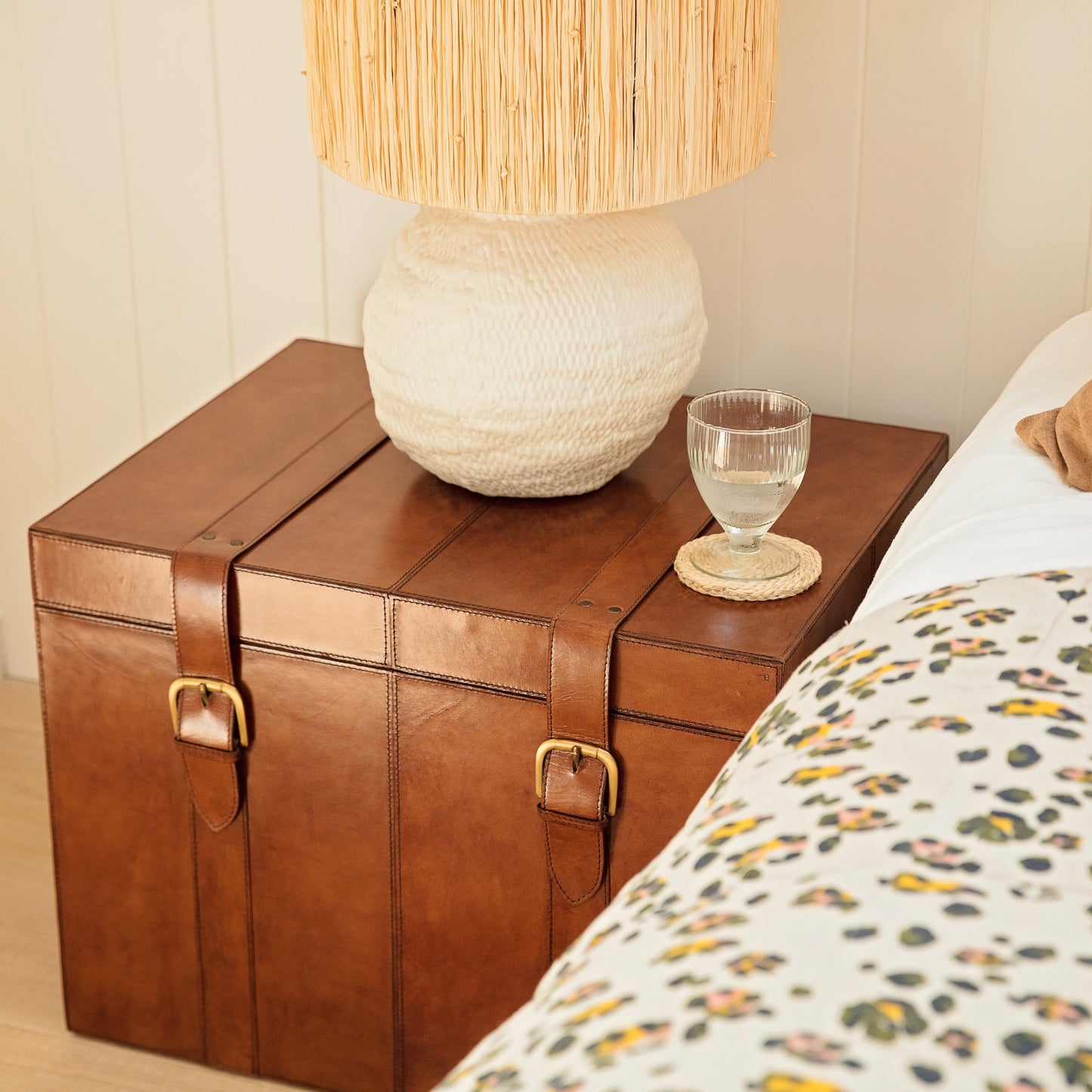 Timeless tan leather storage trunk ottoman with a lid and buckles. Use as a bedside table and personalise to create a wedding day gift to treasure forever.