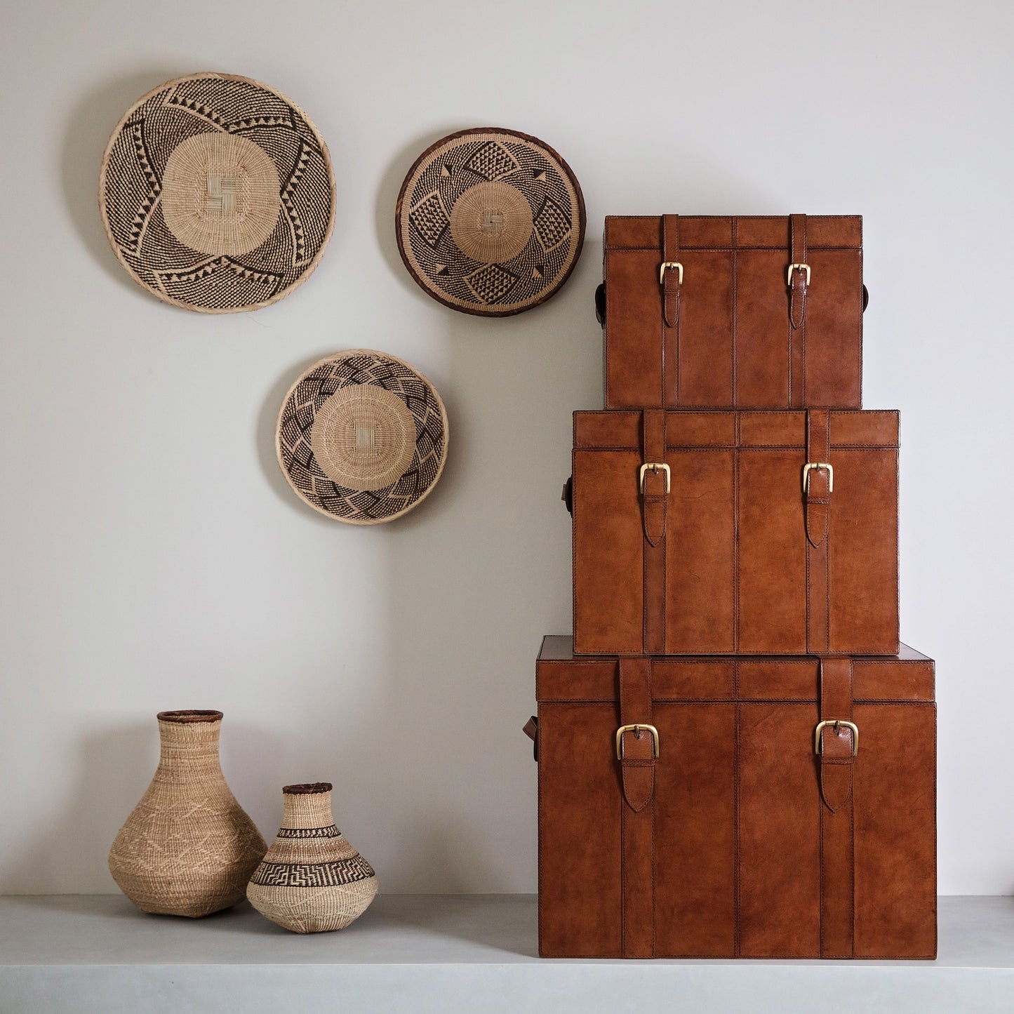 Set of tan leather storage trunks in three sizes with lids and buckles. A timeless heirloom gift for the home or a wedding day gift to treasure forever.