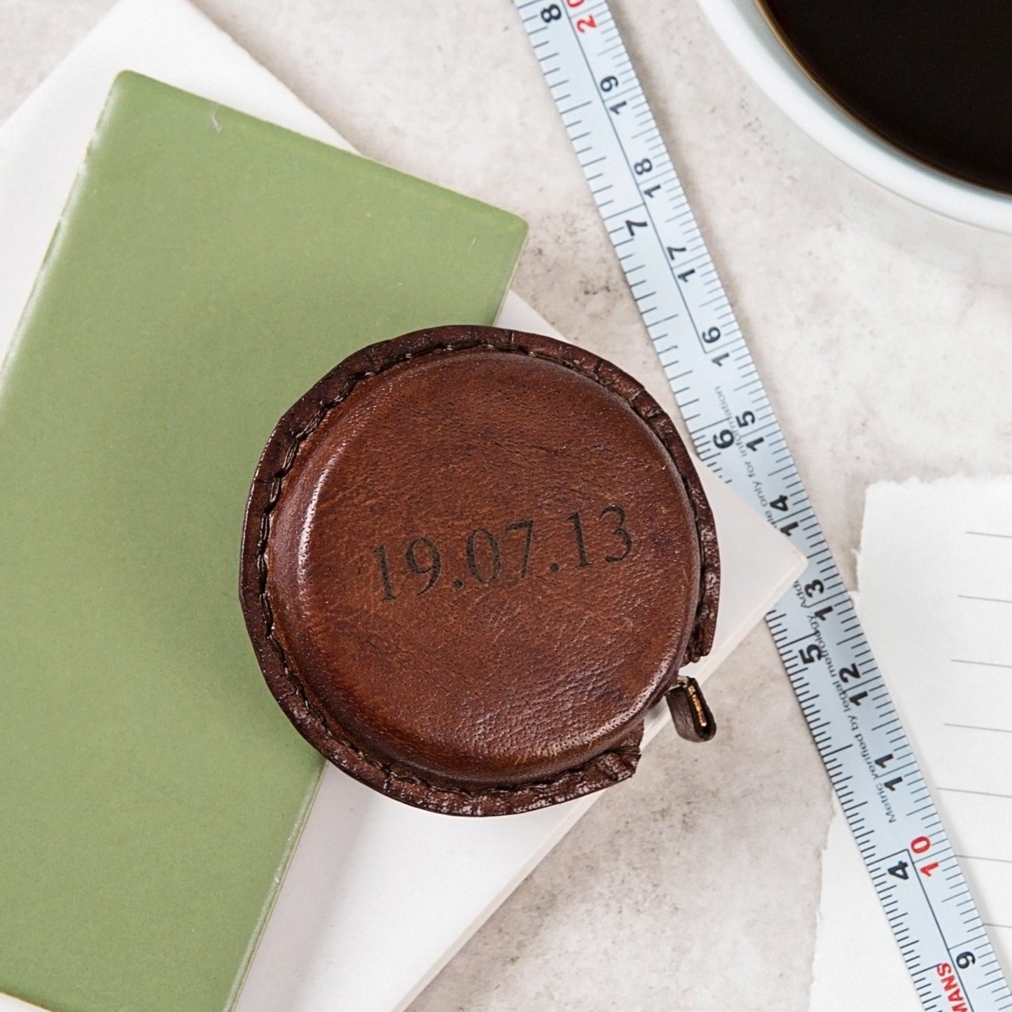 
                  
                    Timeless tan leather pocket sized tape measure. Add initials or a special date for a thoughtful leather anniversary gift.
                  
                