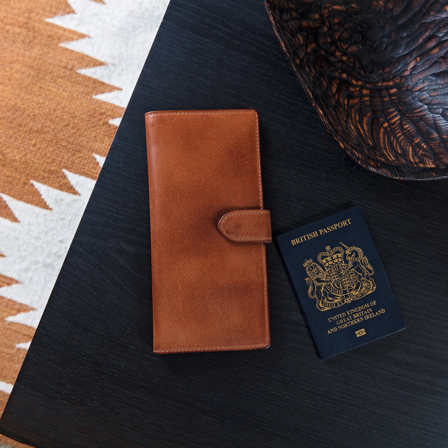 Leather travel wallet for passport and tickets. Made from soft tan leather, it closes with a secure strap and press stud and is RFID protected. Personalise for a unique father’s day gift.