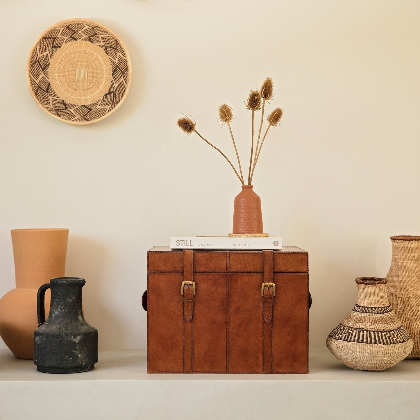 Timeless tan leather storage trunk with a lid and buckles. Use for storing keepsakes or as a memory box.  Personalise with a leather tag to mark a special occasion.