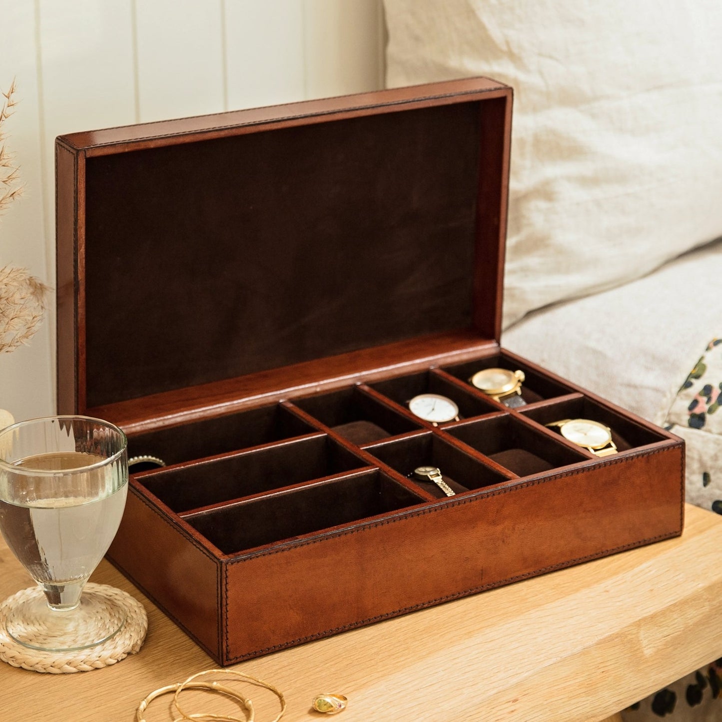 Rectangular tan leather storage box lined with micro suede. With six removable watch pillows and three sections for accessories. Personalise with a name or date as a unique new home or anniversary gift.