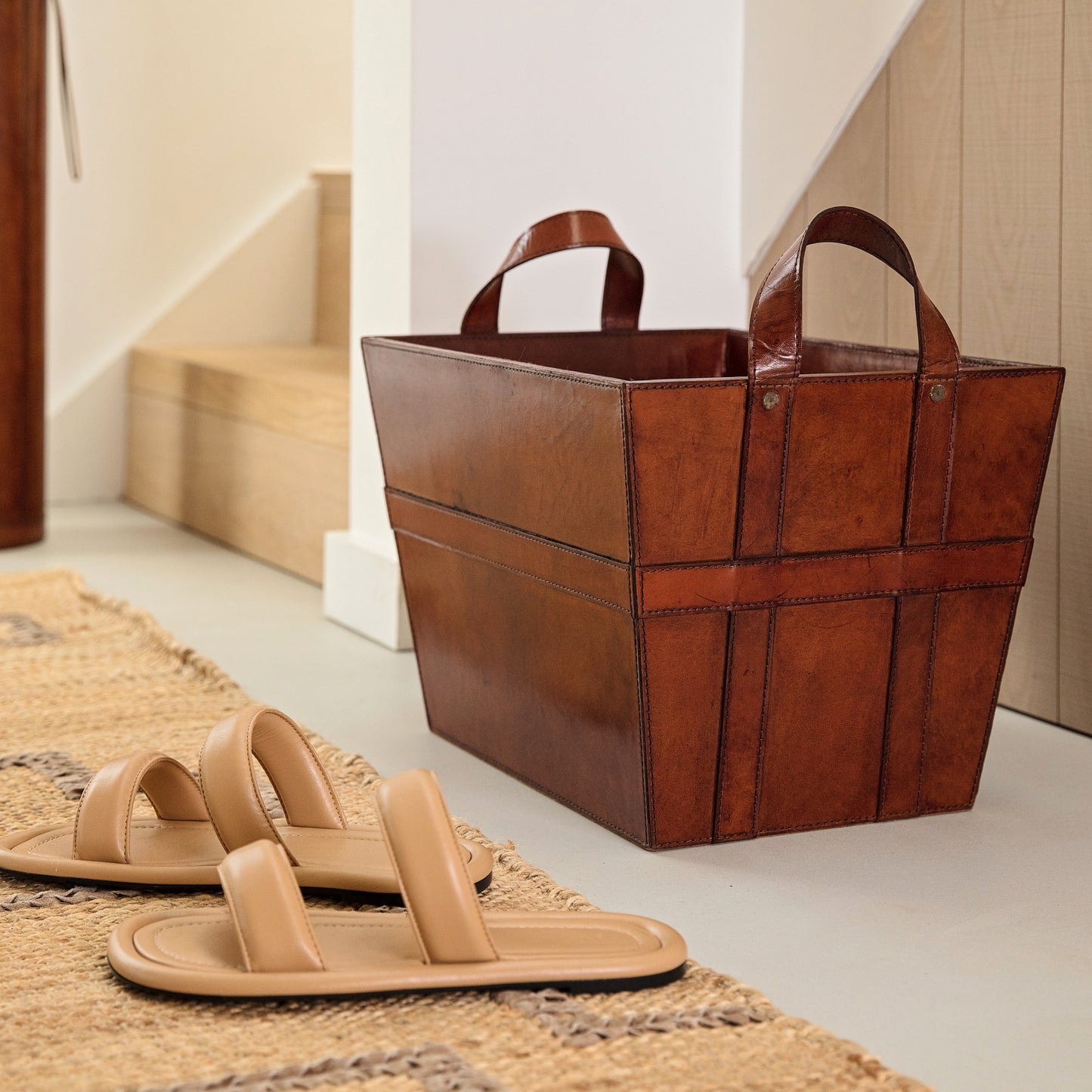 Rectangular tan leather magazine basket with handles. Sturdy and stylish its ideal for storing shoes, accessories or magazines. Personalise with a name to create a unique third anniversary gift.