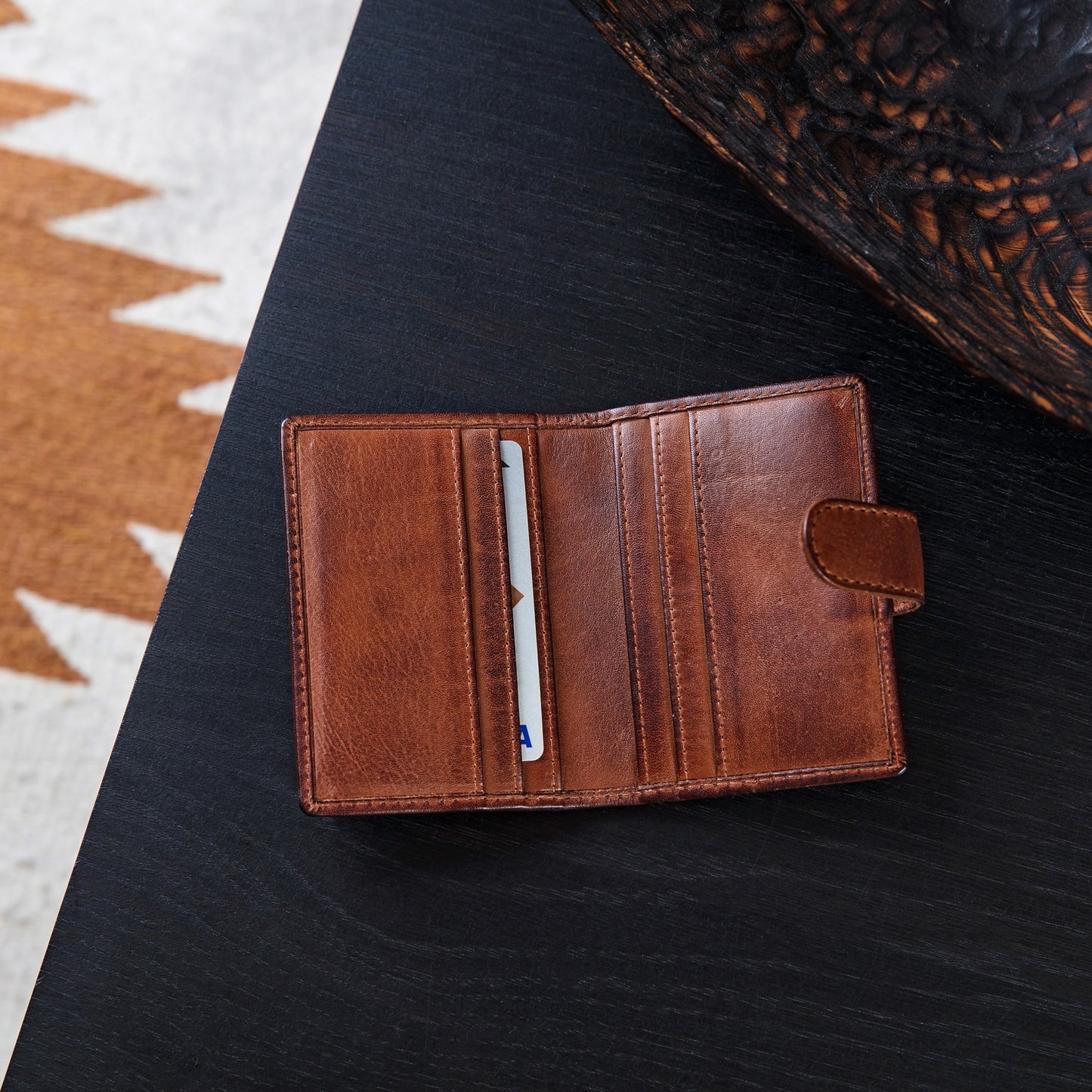 Personalised leather card wallet in soft tan leather, opens up with space for cards and notes and folds in half to close with a secure strap and press stud. Add initials or a message inside for an 18th birthday gift or unique father’s day gift.