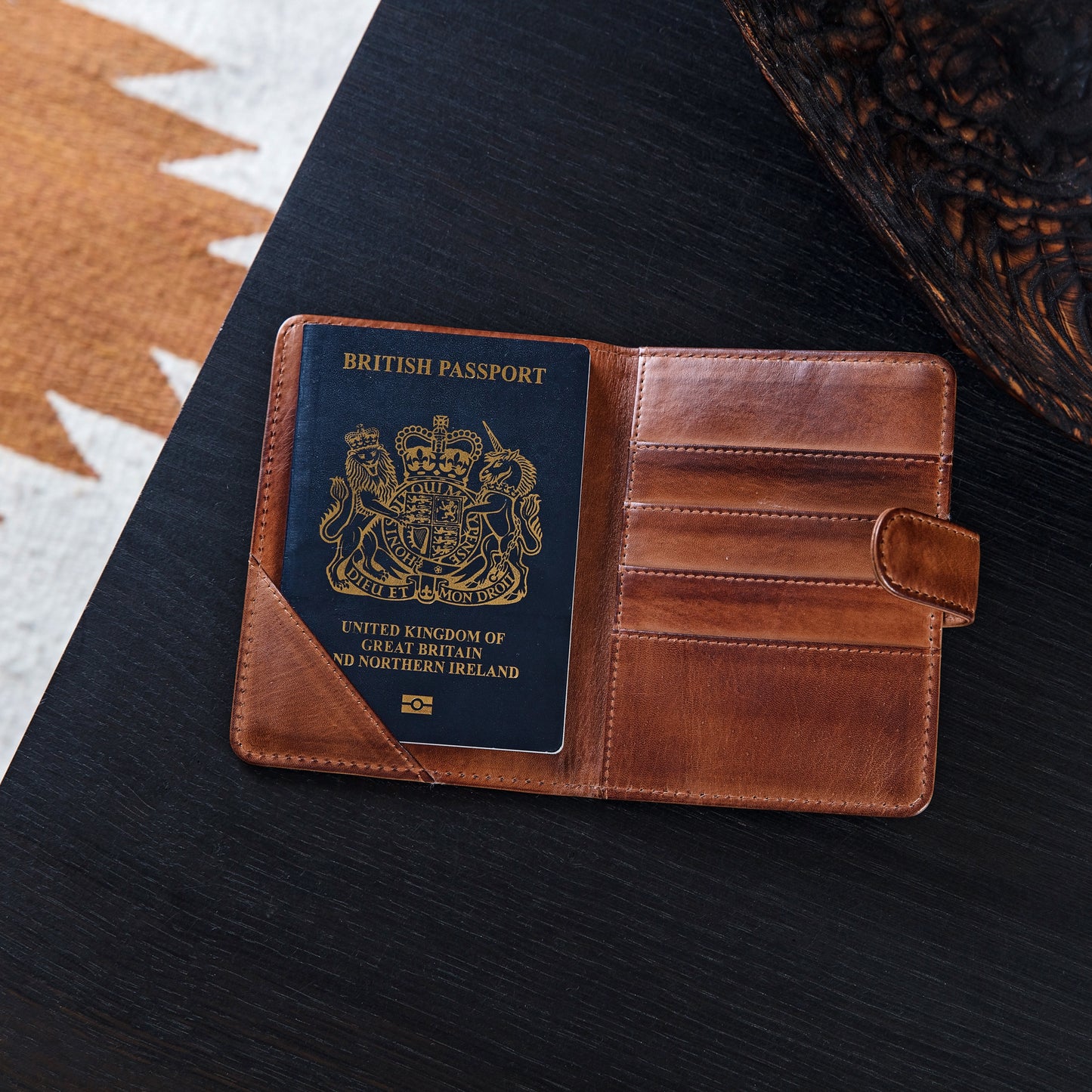 Personalised passport wallet in soft tan leather. Opens up with space for cards and currency and folds in half to close with a secure strap and press stud. Add initials or a message inside for a unique 18th birthday gift idea.