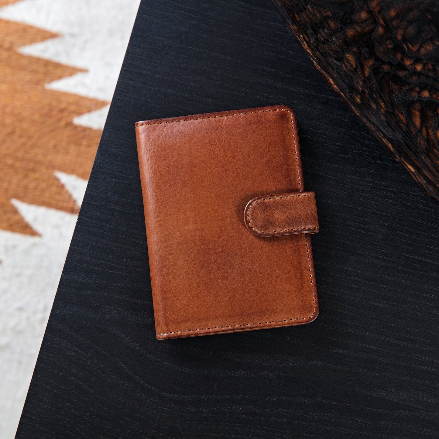 Personalised passport wallet in soft tan leather. Opens up with space for cards and currency and folds in half to close with a secure strap and press stud. Add initials or a message inside for a unique 18th birthday gift idea.