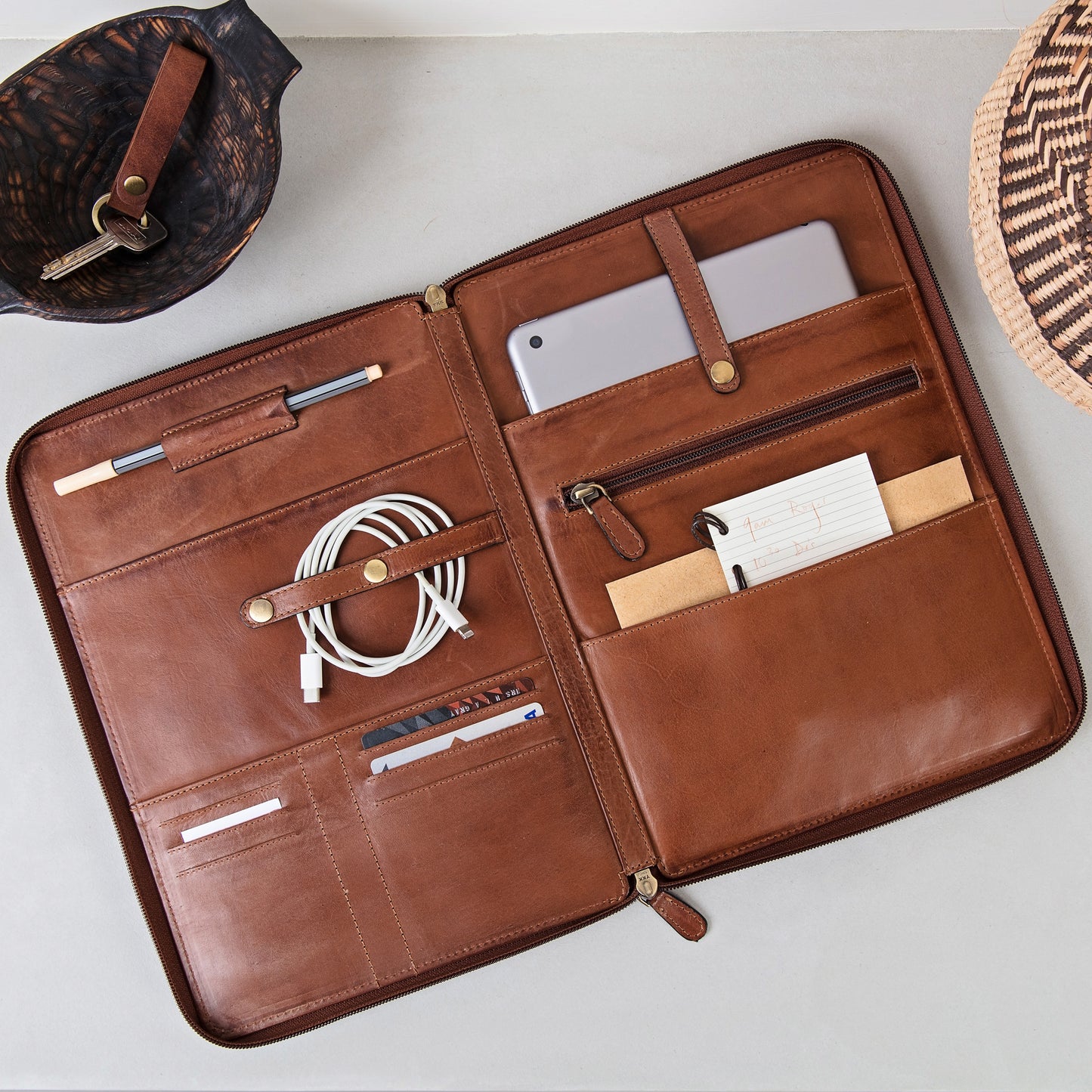 A4 sized zippable leather portfolio. Handmade with soft tan leather and RFID protected, it can be personalised to make a thoughtful gift for him or her.
