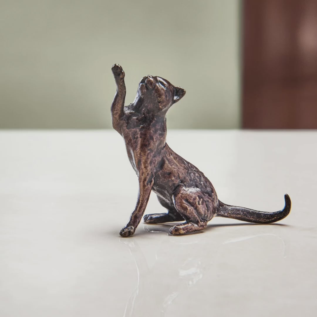 Load and play video in Gallery viewer, Miniature bronze figurine of a cat playfully pawing the air. A perfect bronze anniversary gift.
