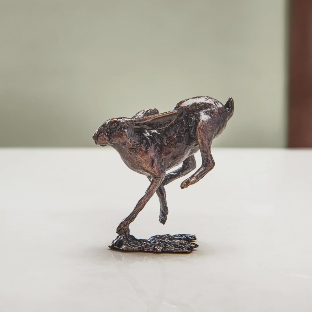 Load and play video in Gallery viewer, Miniature bronze figurine of a running hare. Give as a bronze anniversary gift or thoughtful birthday gift.