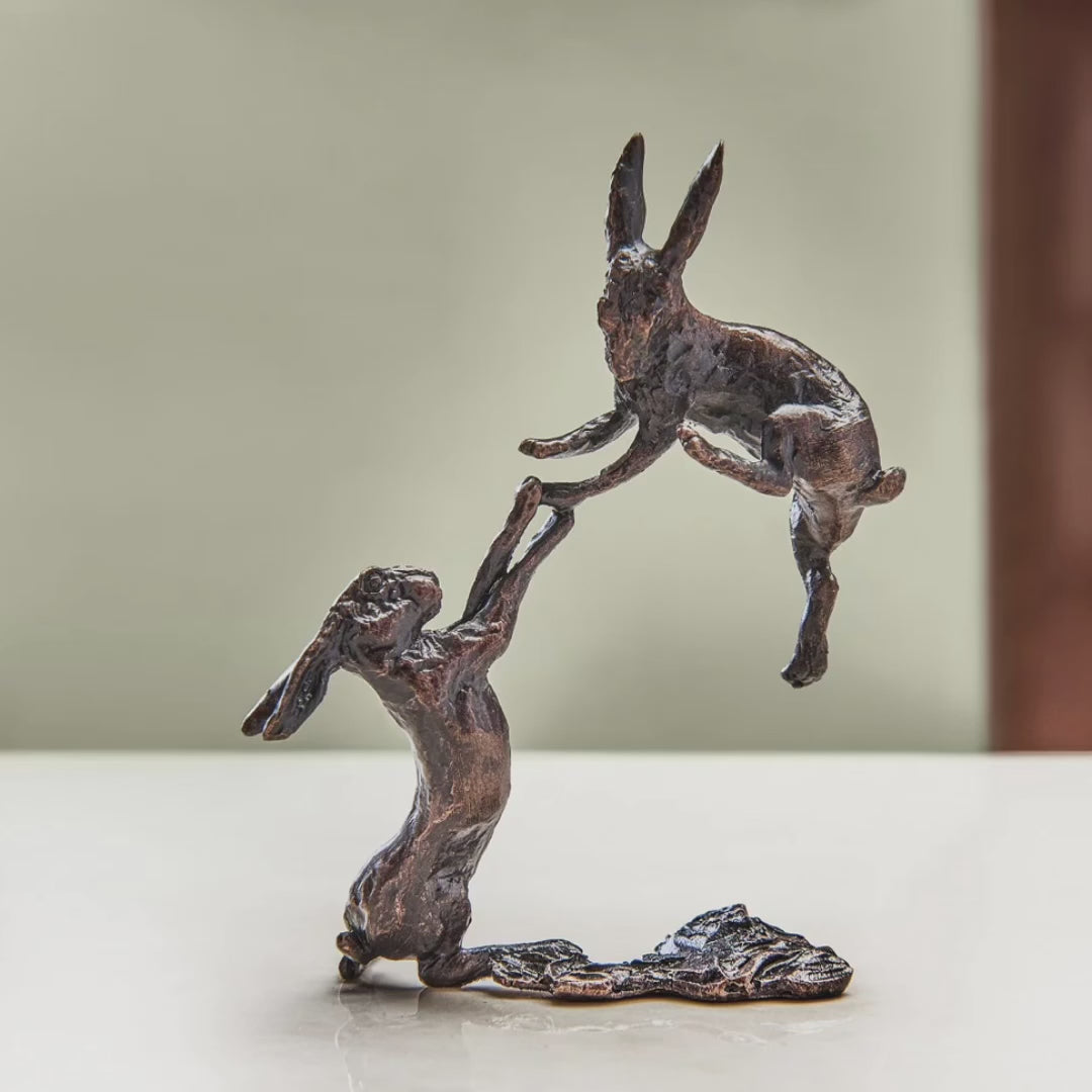 Load and play video in Gallery viewer, Miniature bronze figurine of a pair of boxing hares. A thoughtful springtime birthday gift or gift to celebrate an 8th wedding anniversary.
