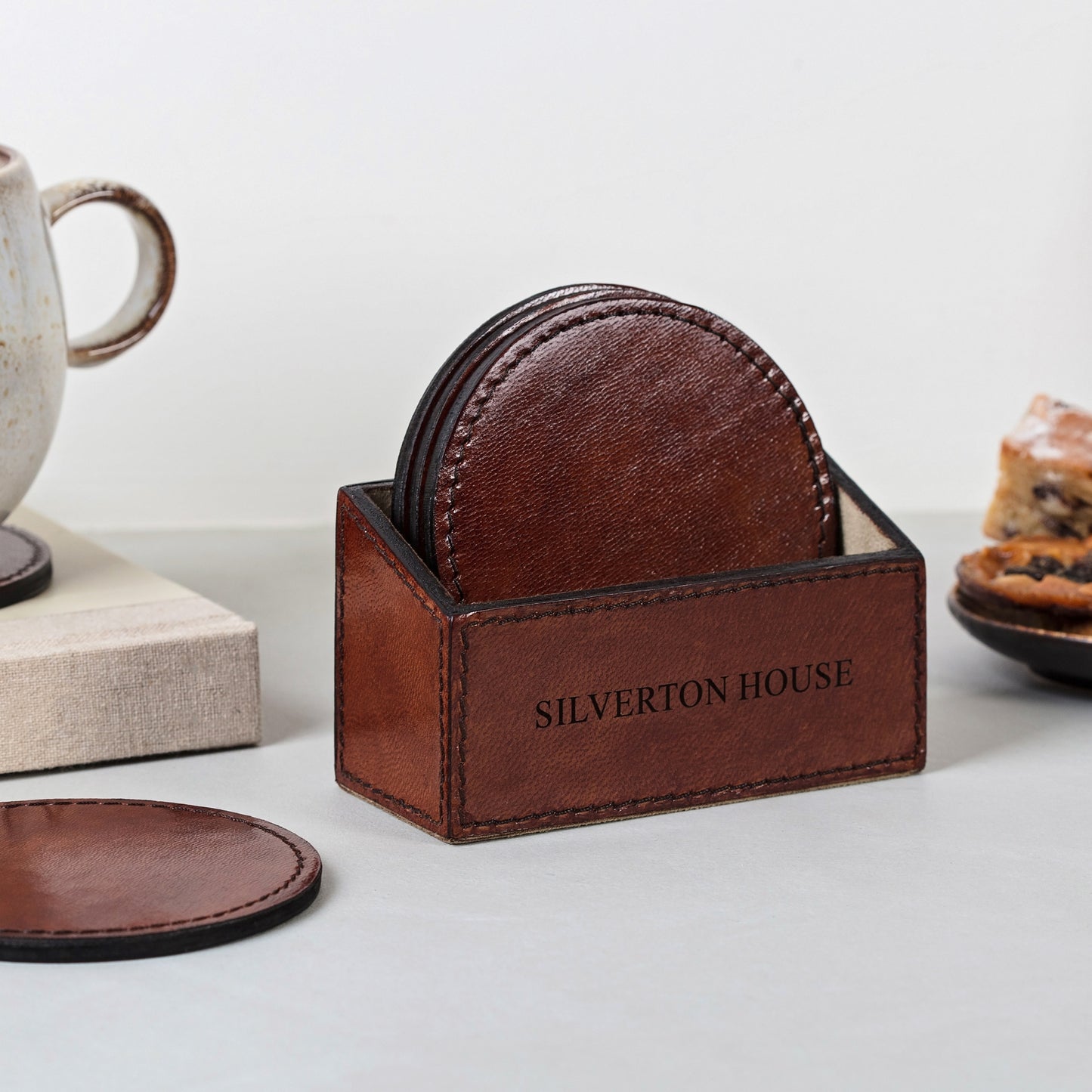 Set of six round leather coasters in a holder. Can be personalised to create a unique third anniversary, Mother's Day or housewarming gift.