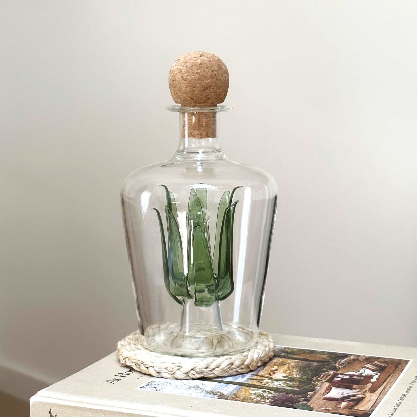 Unique glass tequila decanter with green glass agave leaves inside and a round cork stopper. Ideal as a gift for a housewarming, wedding or special birthday.
