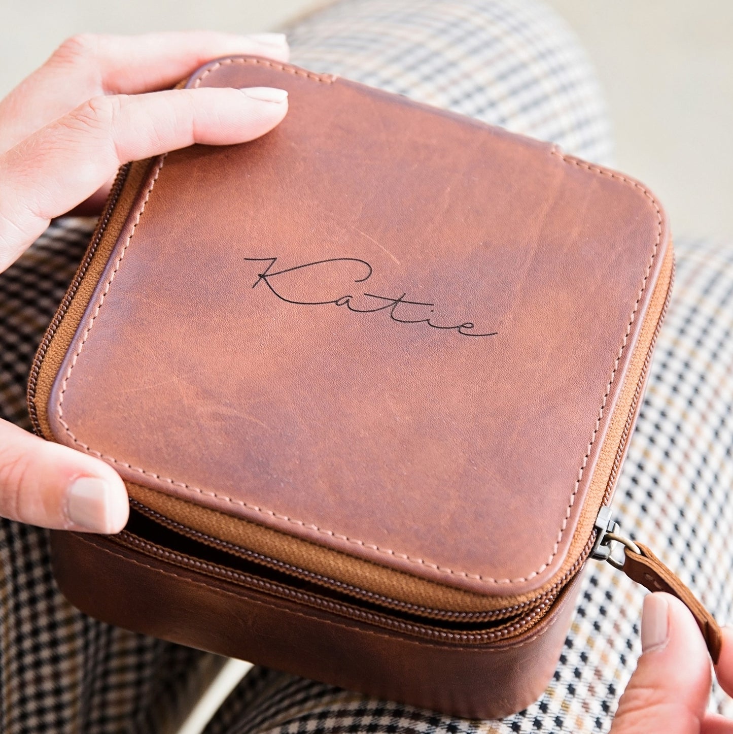 Square tan leather travel jewellery box with zip closure. Ideal for keeping a watch, bracelets and necklaces secure whilst travelling. Personalise with a name, or message as a thoughtful 30th birthday gift for your daughter.