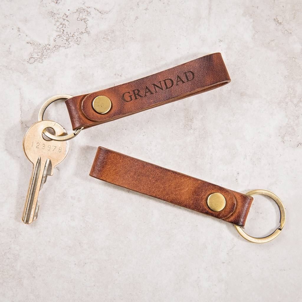 Personalised leather keyring made from soft tan leather, looped for easy hanging. Add initials or a name for a unique new home gift or to gift them keys to their first car.