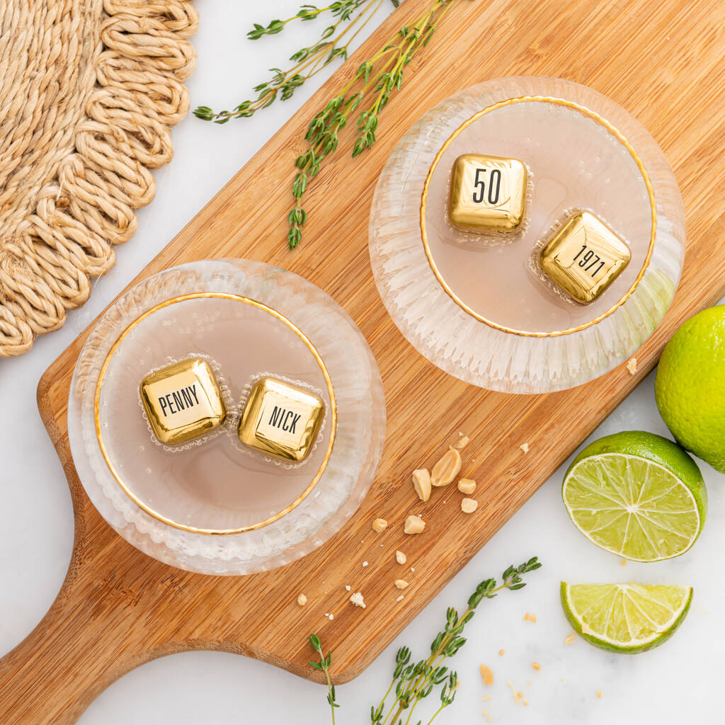 
                  
                    Set of four personalised gold finish stainless steel ice cubes. Add initials, names or dates to create a thoughtful golden wedding anniversary gift.
                  
                