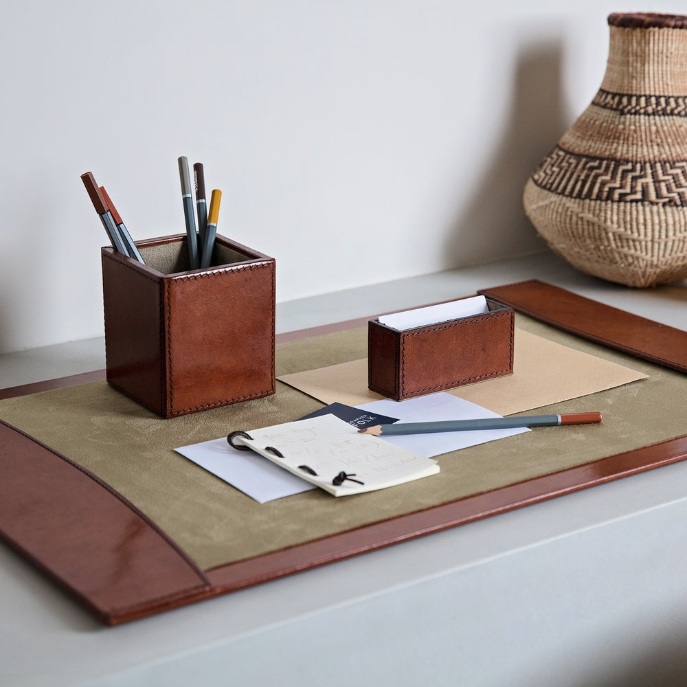 Office desk set in tan leather, combining a stylish pen pot, business card holder and leather desk blotter. Personalise for a thoughtful gift to celebrate Father’s Day or a special birthday.