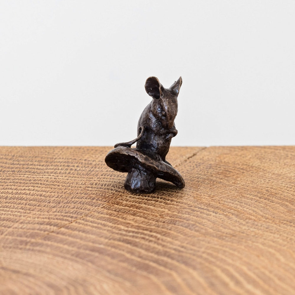 Miniature bronze figurine of a mouse sitting onto of a mushroom. Give as an 8th anniversary gift or for a special birthday.