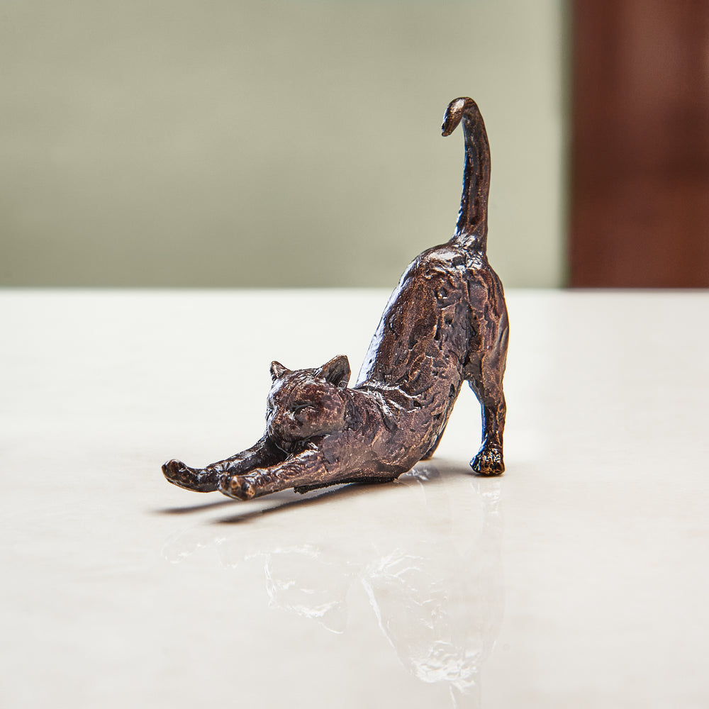 Miniature bronze figurine of a cat stretching out its front paws. A perfect bronze anniversary gift.