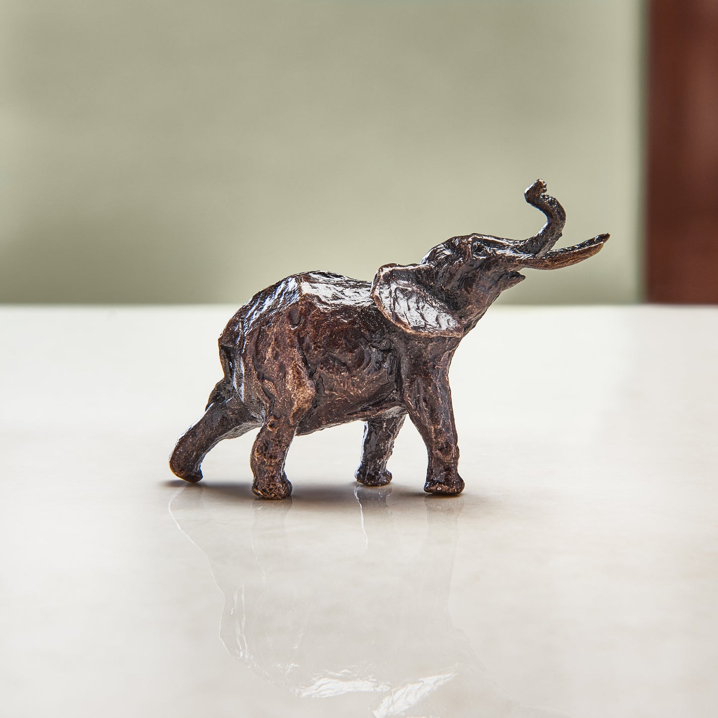 
                  
                    Miniature bronze figurine of an elephant. Give as a bronze anniversary gift or thoughtful birthday gift.
                  
                